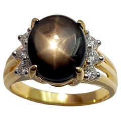 Schwarzer Sternsaphir mit Diamantring in 18K Goldfassung