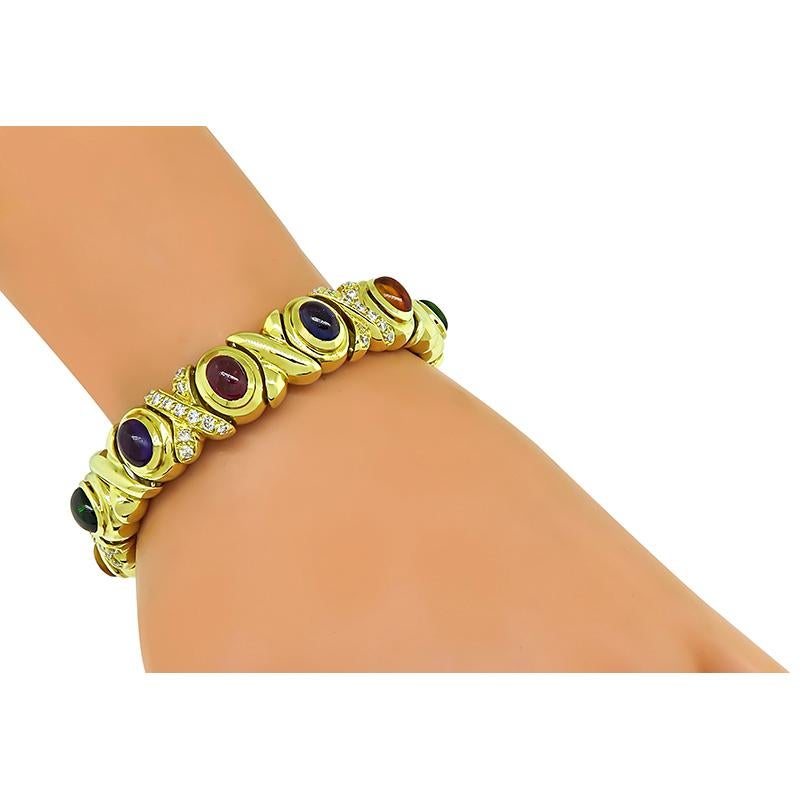 This is a stunning 18k yellow gold bracelet by Black Starr and Frost. The bracelet features lovely cabochon multi color semi precious stones that weigh approximately 30.00ct. The semi precious stones are accentuated by sparkling round cut diamonds