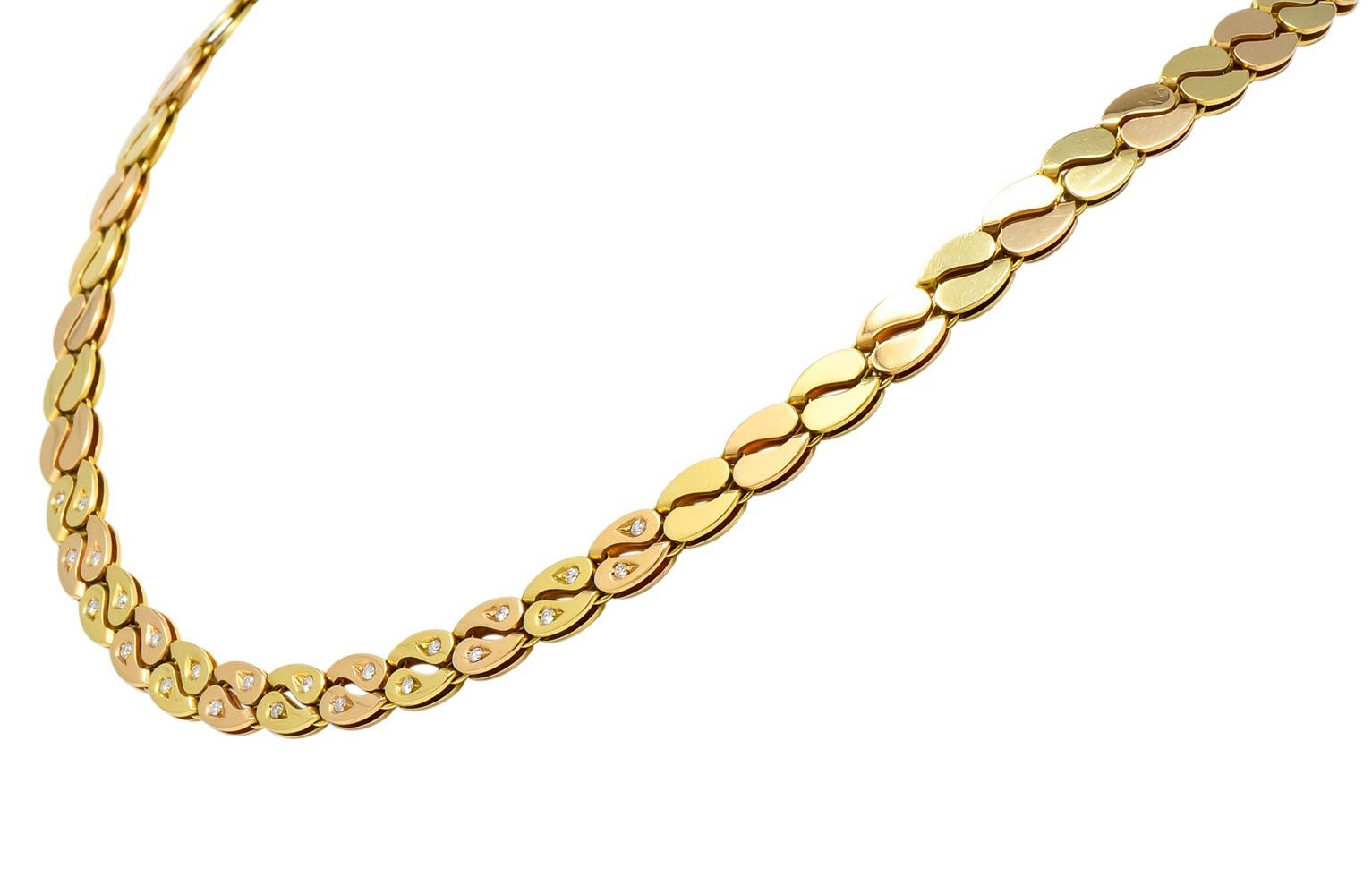 Collar style necklace with two nesting parallel drops that create stylized curbed links

Alternating yellow and rose gold

Set to front with round brilliant diamonds weighing approximately 0.36 carat total, G/H color and VS clarity

Completed by