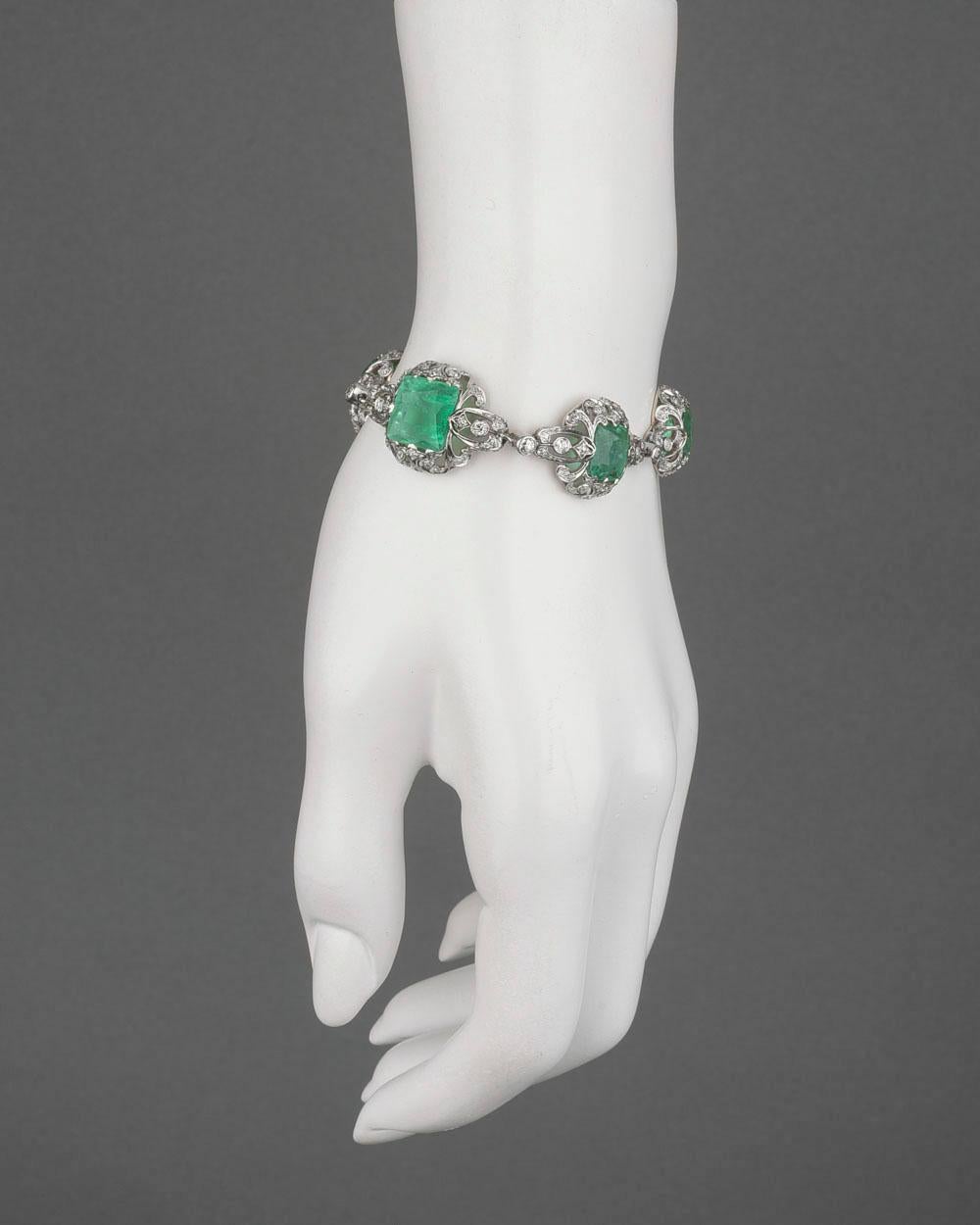 Antique emerald and diamond bracelet, set with six cushion-shaped emeralds of graduated size, the emeralds weighing approximately 20.37 total carats, accented by circular-cut diamonds weighing approximately 3.95 total carats, in a fine pierced