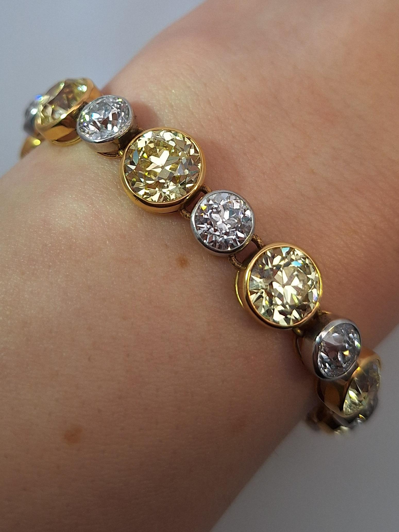 The bracelet of graduated design, set with 12 old European-cut yellow diamonds alternating with 12 old European-cut near colorless diamonds.

GIA reports:
No. 2165486745 stating that the 3.14 carat diamond is Fancy Yellow, Natural Color, VS1