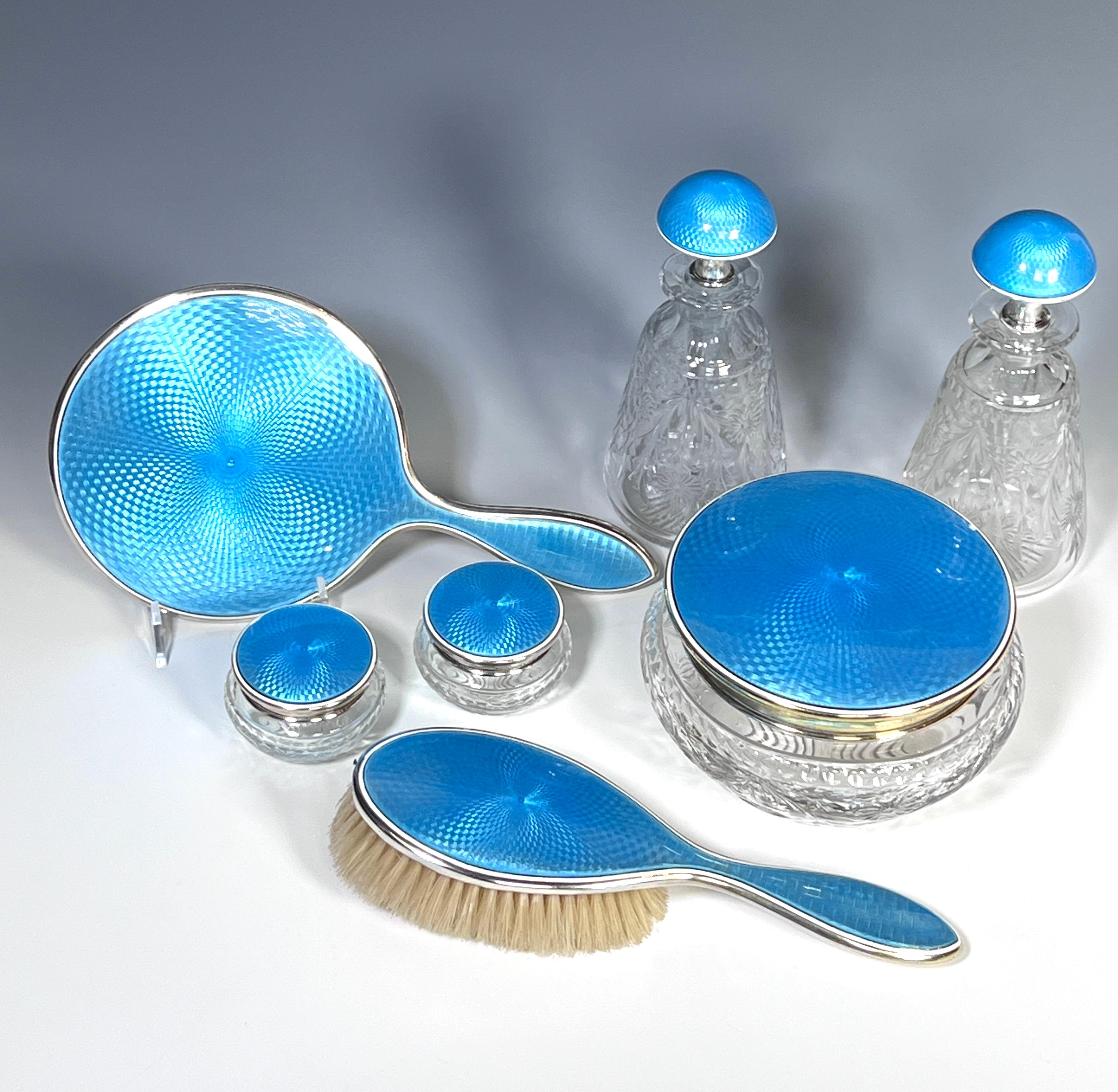 This dresser set is made by two masterful companies to create an exquisite 7 piece set featuring vibrant turquoise enamels with hand blown crystal perfumes, (6.88