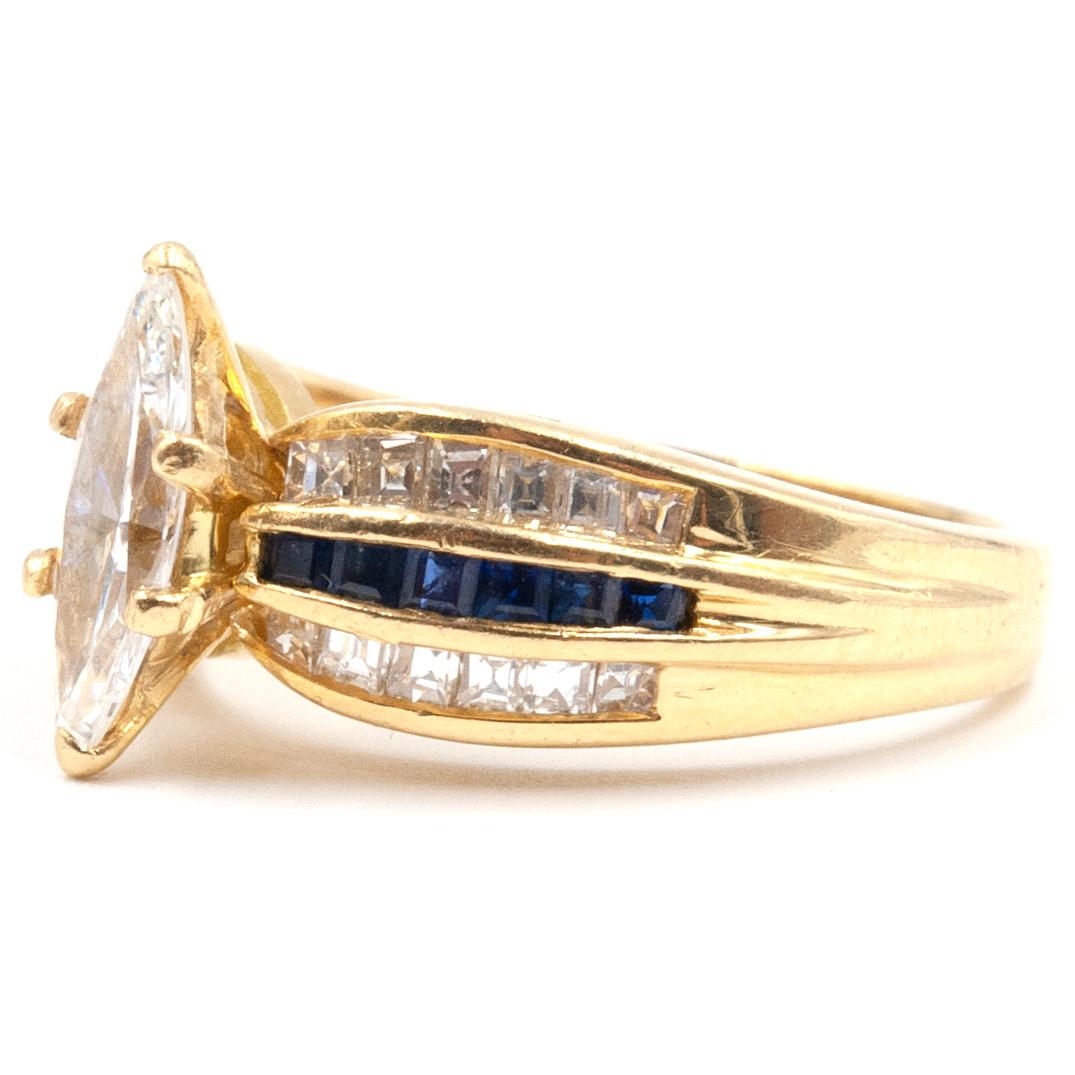 A Black Starr & Frost Marquise Diamond ring. Featuring a  .75. Marquise Diamond showing VVS clarity, Twelve Carre cut cut Blue Sapphire gemstones with vivid color appx. .25 ct. Twenty Four Carre cut cut Diamonds decorate this band giving it an