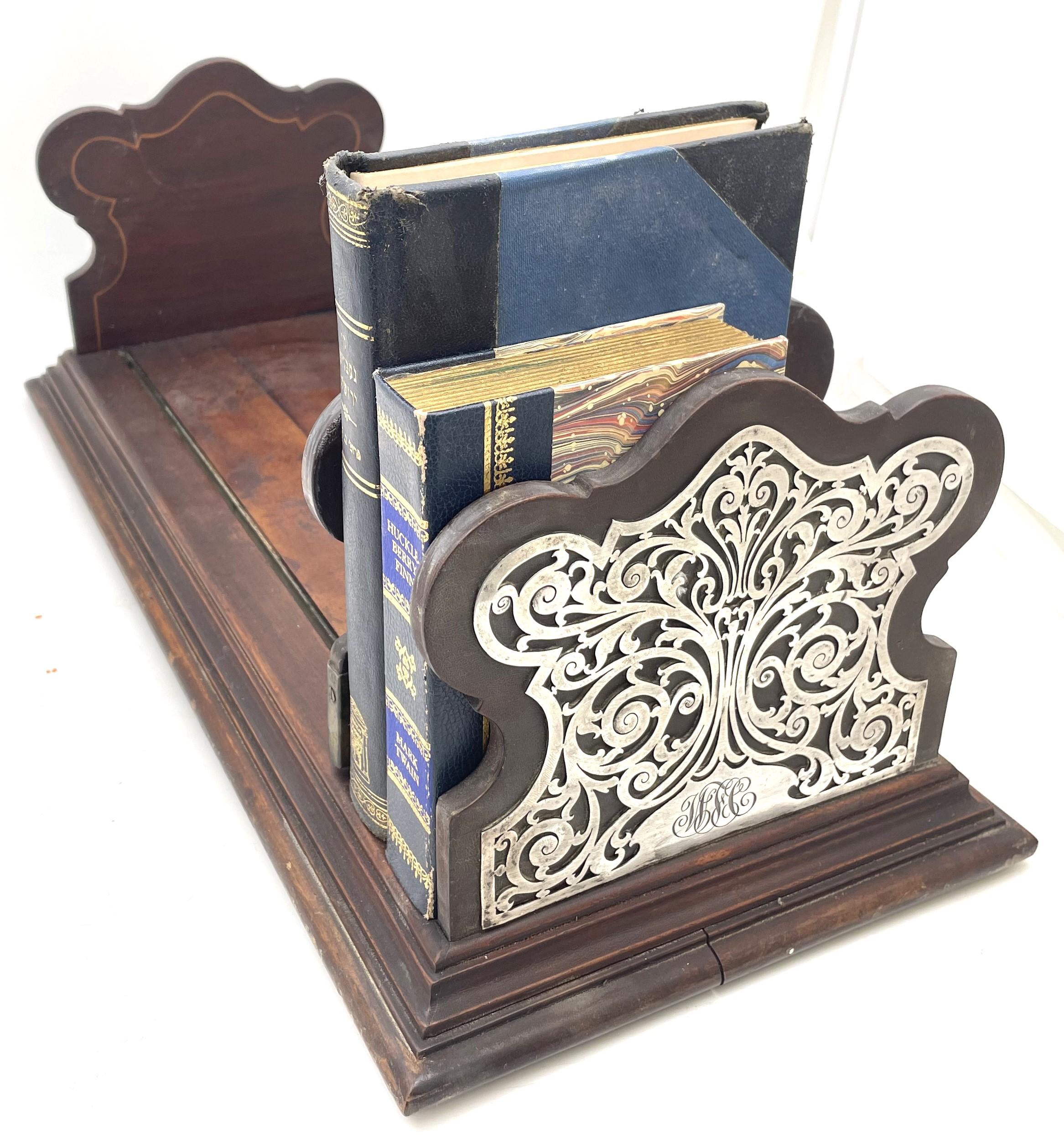 Rare Black, Starr & Frost sterling silver and mahogany wood bookshelf or holder, with an adjustable divider, presumably from the late 19th or early 20th century, beautifully adorned with curvilinear sterling silver motifs on either end of the piece.