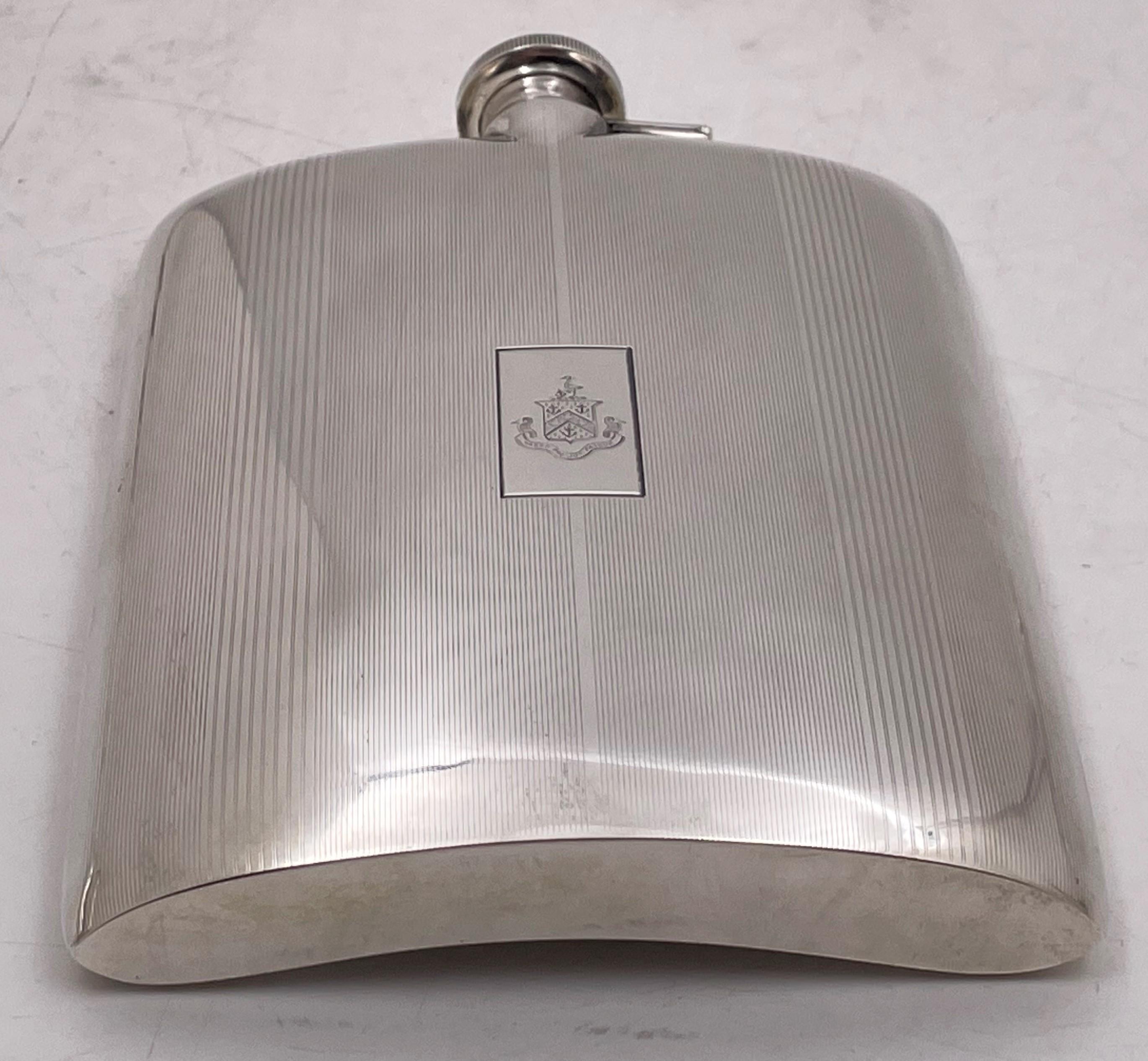 Black, Starr & Frost sterling silver flask from the early 20th century and in Art Deco style with an elegant, geometric design. It measures 6 3/4'' in height by 5 1/8'' in width by 1'' in depth, and bears hallmarks as shown. 

The oldest