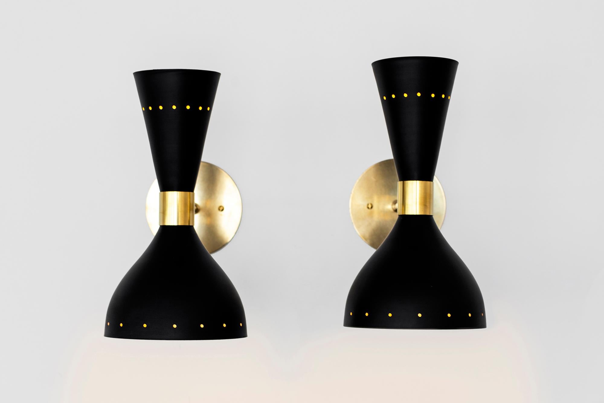 Great pair of Italian metal sconces in the style of Stilnovo, newly produced in Italy. 
Black metal shade with brass detailing and back-plate.
Sconces shine both up and down light.
Wired to American standards.
 