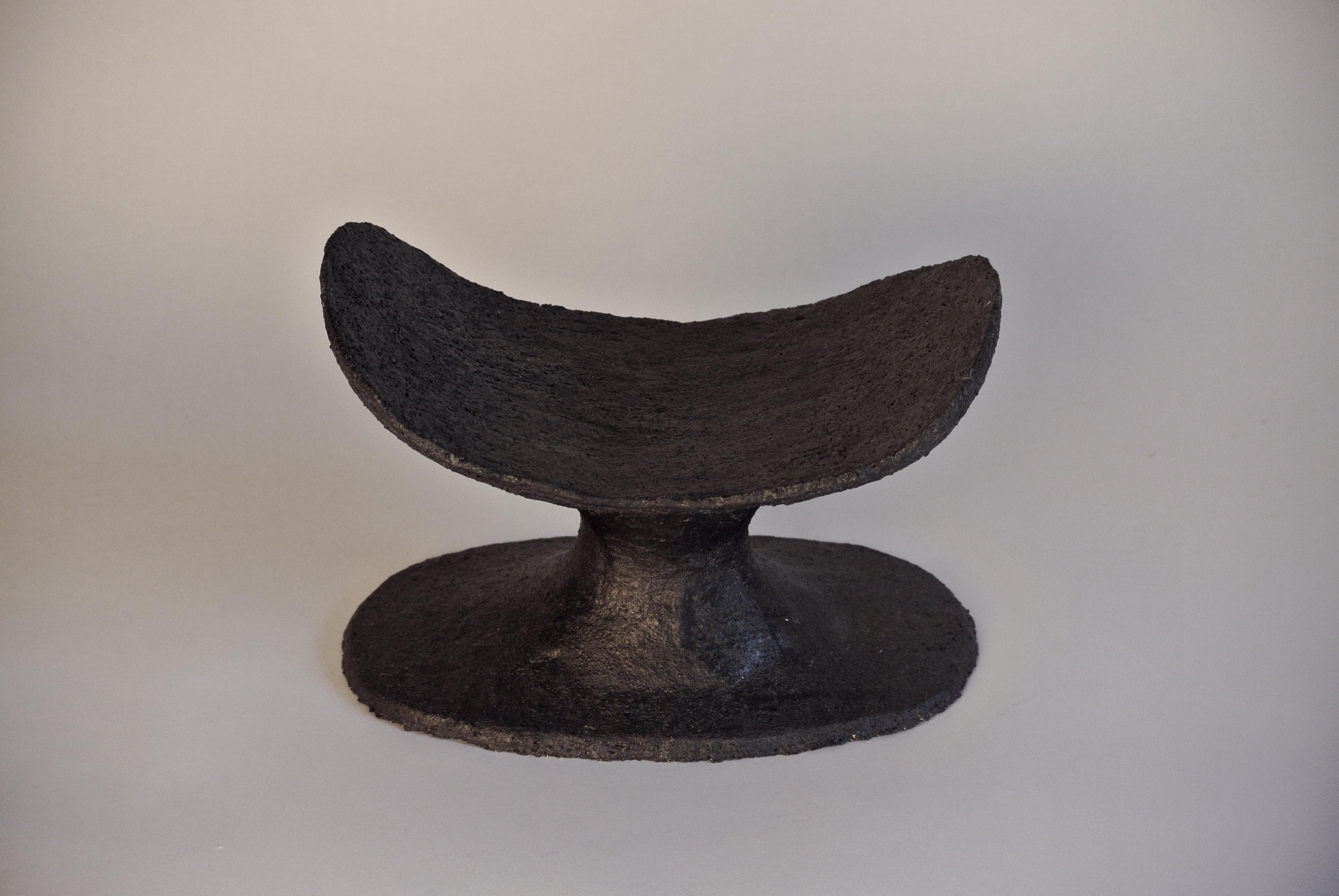 Black rough stoneware head rest with chamotte and black metallic glaze by Danish artist Christine Roland.