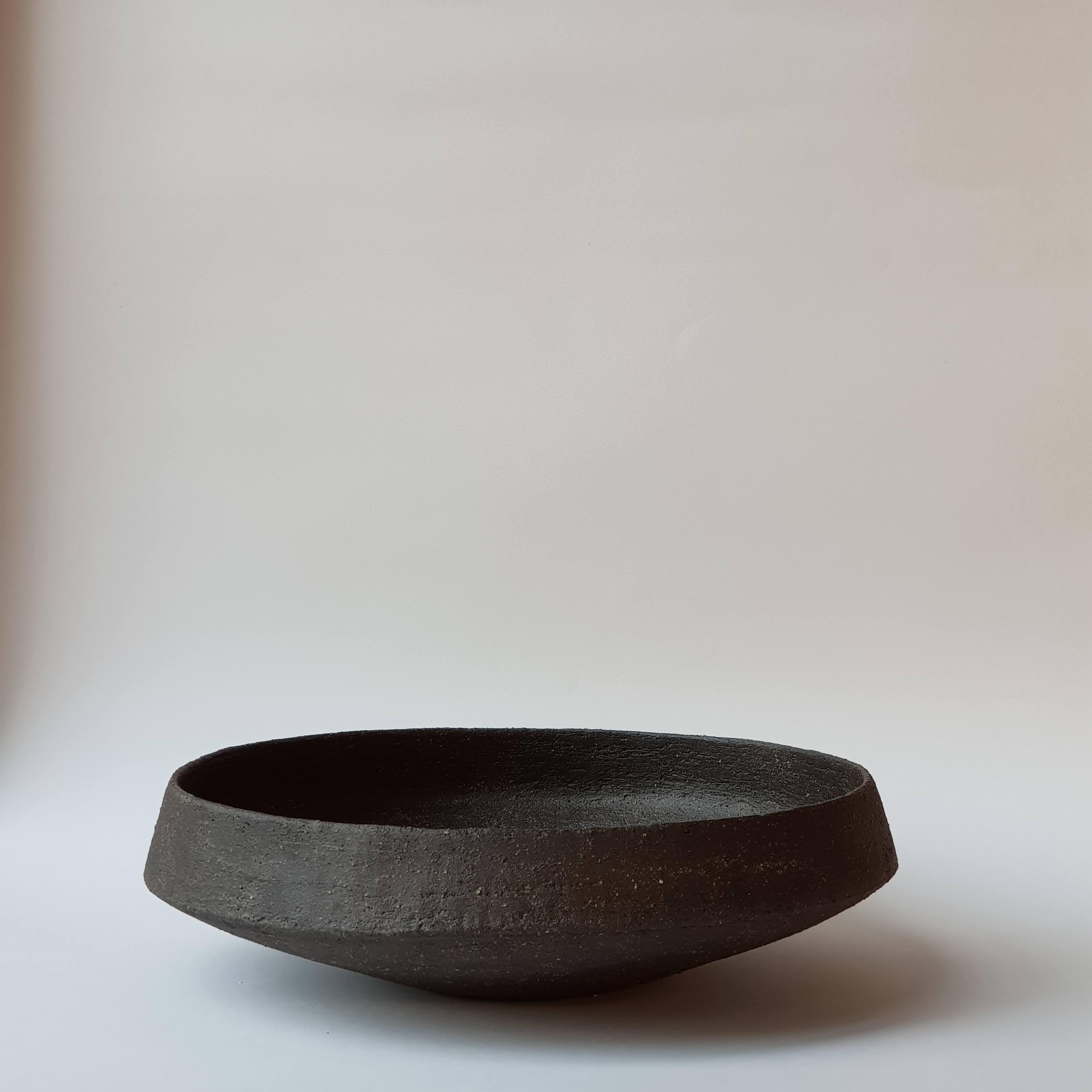 Black Stoneware Pinakio Plate by Elena Vasilantonaki
Unique
Dimensions: ⌀ 34 x H 10 cm (Dimensions may vary)
Materials: Stoneware
Available finishes: With\without handles - Black, White, Grey , Brown, Red, White Patina

Growing up in Greece I was