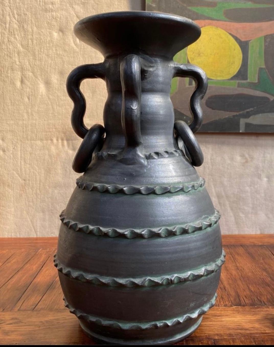 Black stoneware ceramic jar or vase with soft semi-matte finish and whimsical decorative accenting, from 1970s Spain.

Spain, circa 1970

Dimensions: 22H x 14D