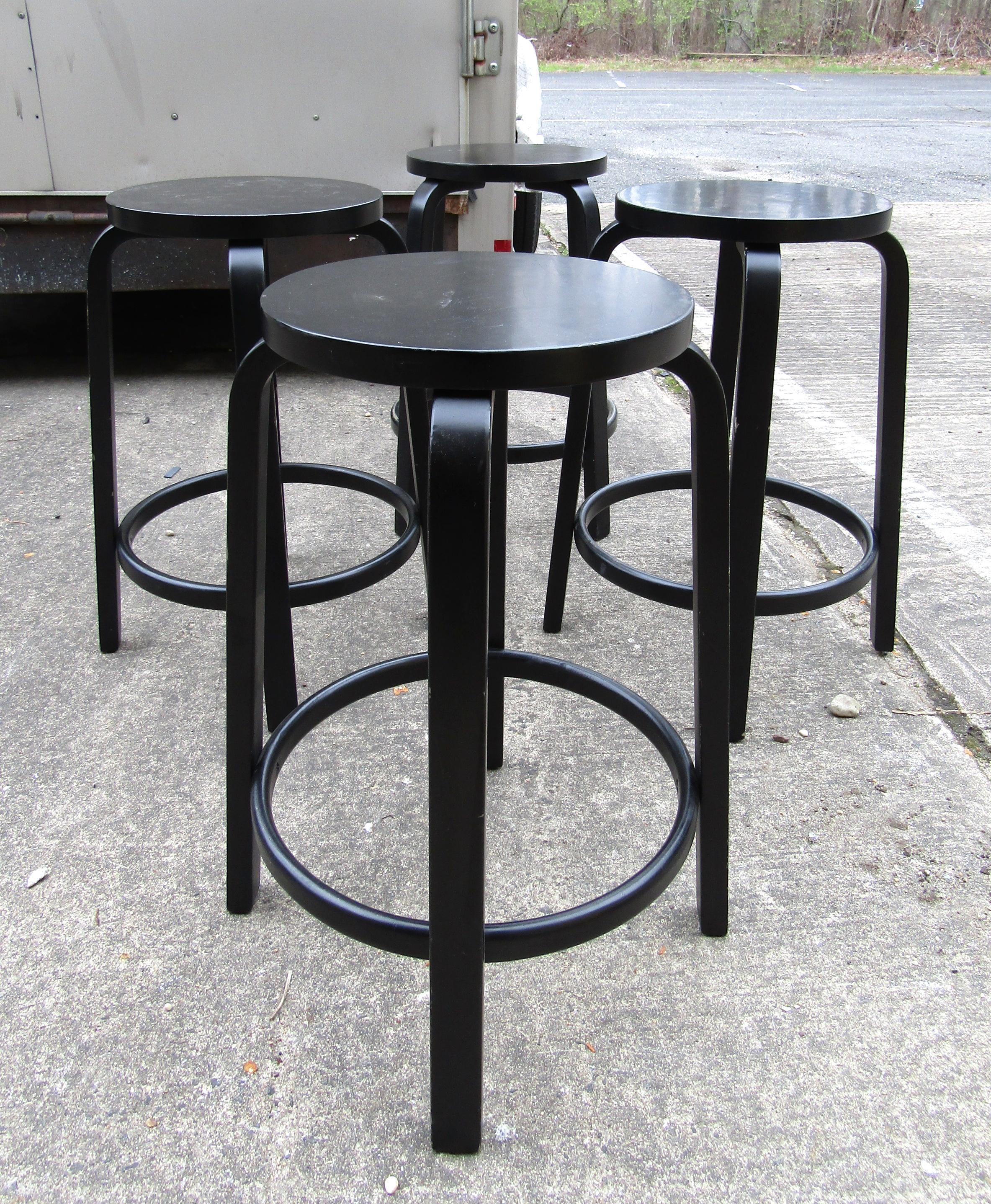 Contemporary black stools featuring a birch footrest, by Alvar Aalto & Artek.

(Please confirm item location - NY or NJ - with dealer).
 