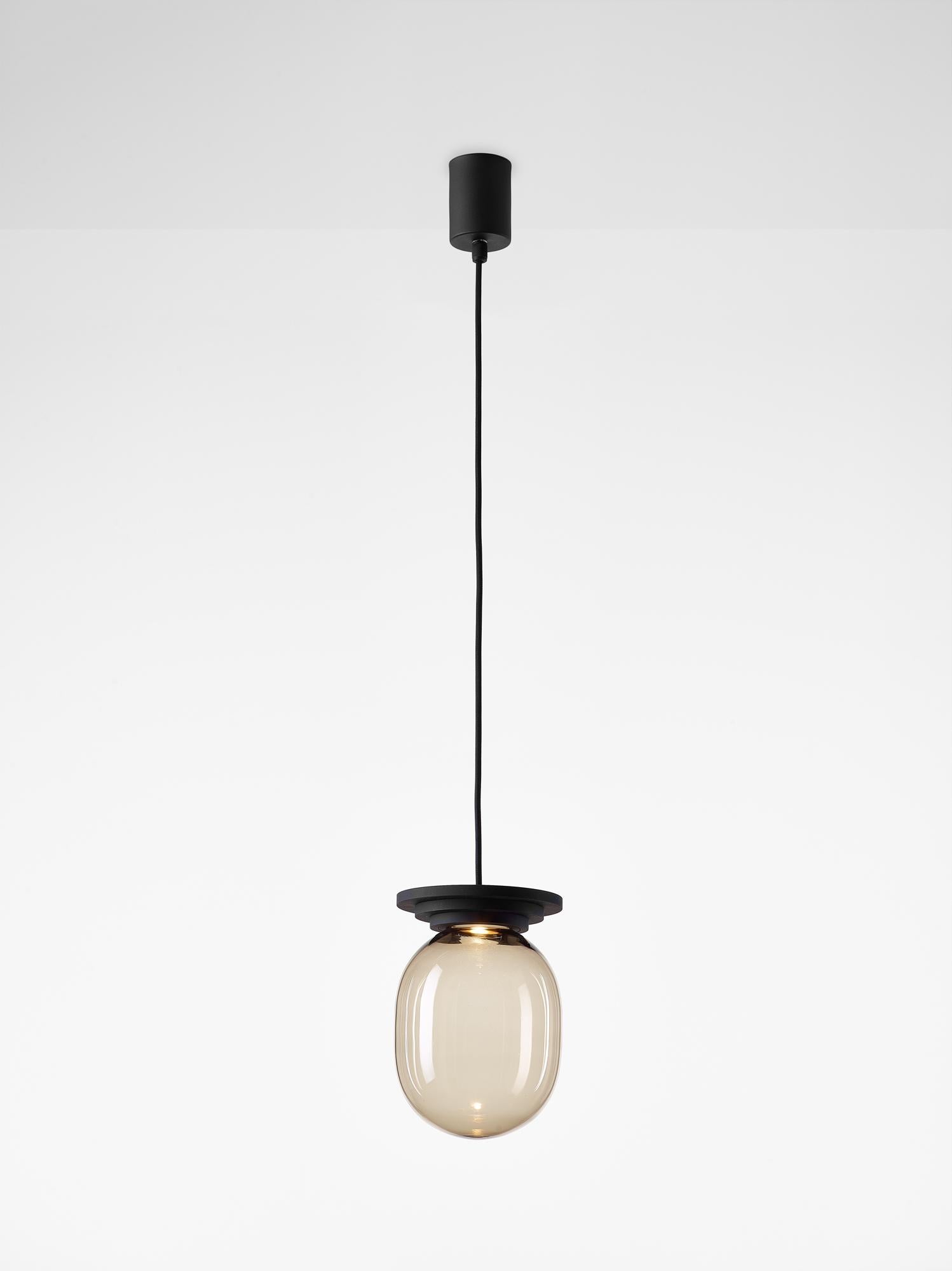 Black stratos big capsule pendant light by Dechem Studio
Dimensions: D 20 x H 28 cm.
Materials: aluminum, glass.
Also available: different colours available.

Different shapes of capsules and spheres contrast with anodized alloy fixtures,