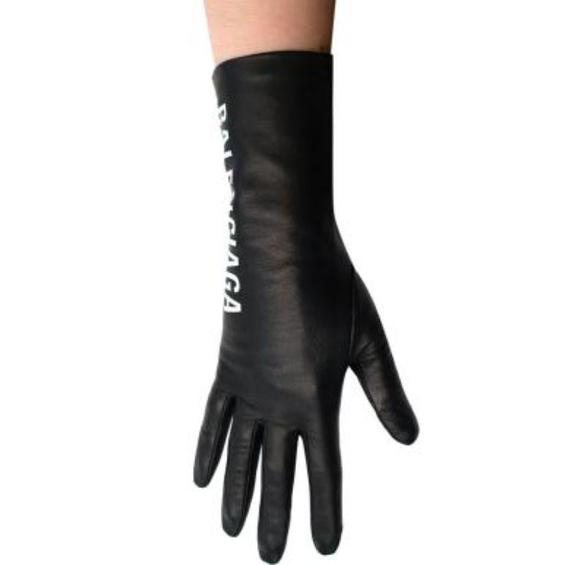 Balenciaga black stretch leather logo gloves
 

 - Supple black leather gloves 
 - Bold logo print in white to the right side of right-hand glove
 - Lined
 

 Materials 
 Leather 
 Polyester
 

 Made in France 
 

 PLEASE NOTE, THESE ITEMS ARE