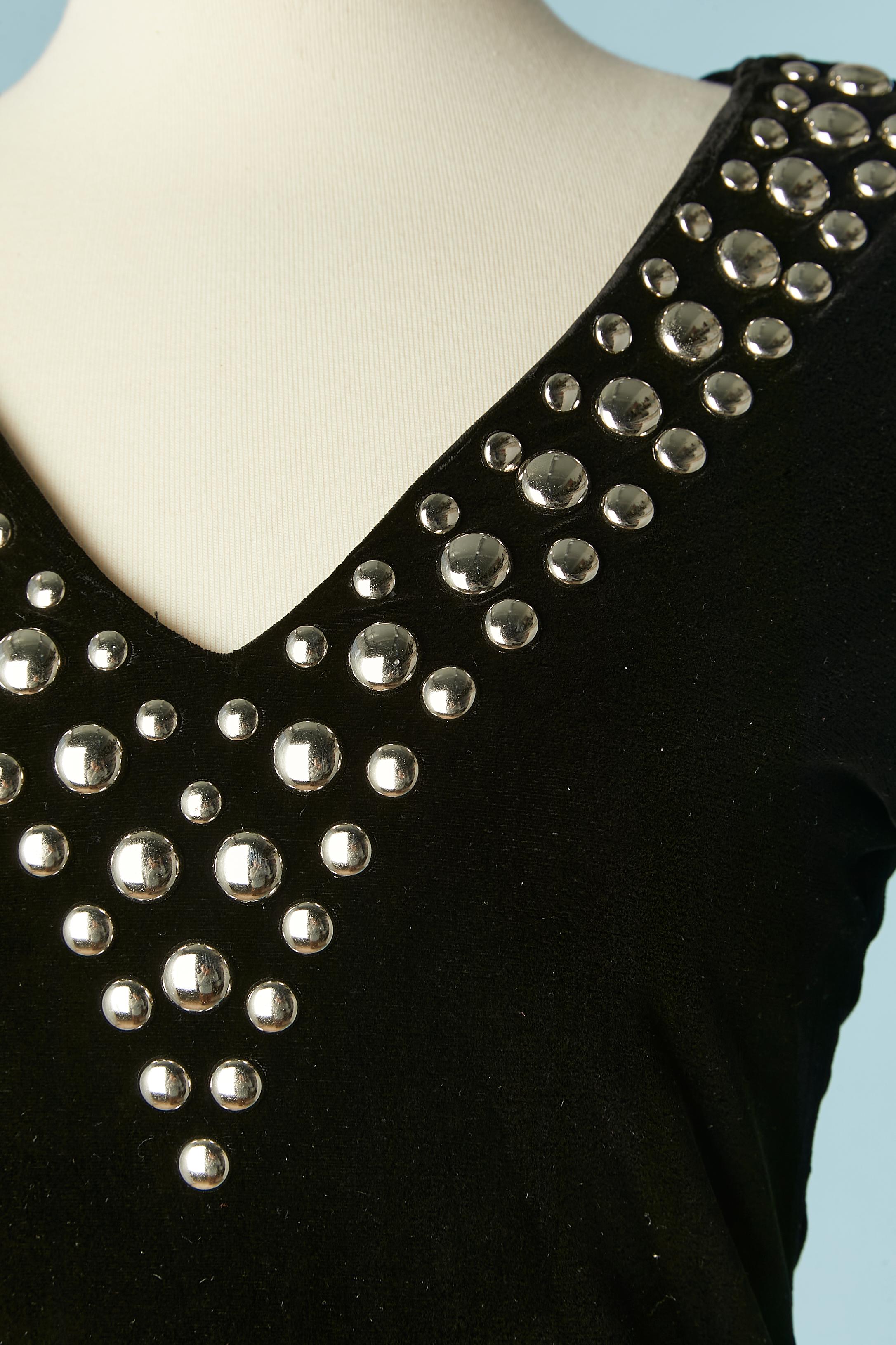 Black stretch velvet cocktail dress with silver studs . 
Main fabric composition: 77% rayon, 20% silk, 3% elastane . Lining: 100% polyamide. 
Silver studs: Aluminium 
Zip closure in the middle back. Shoulder pads. 
SIZE 38 (Fr) M 