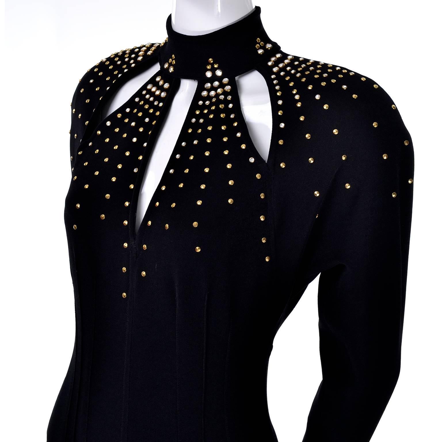 This stunning stretchy black jumpsuit is by Tadashi with triangle cutouts on the bust, adorned with gold studs and clear gems. This 1980s jumpsuit has shoulder pads under the raglan long sleeves. The ankles are tapered and have elastic stirrups. The
