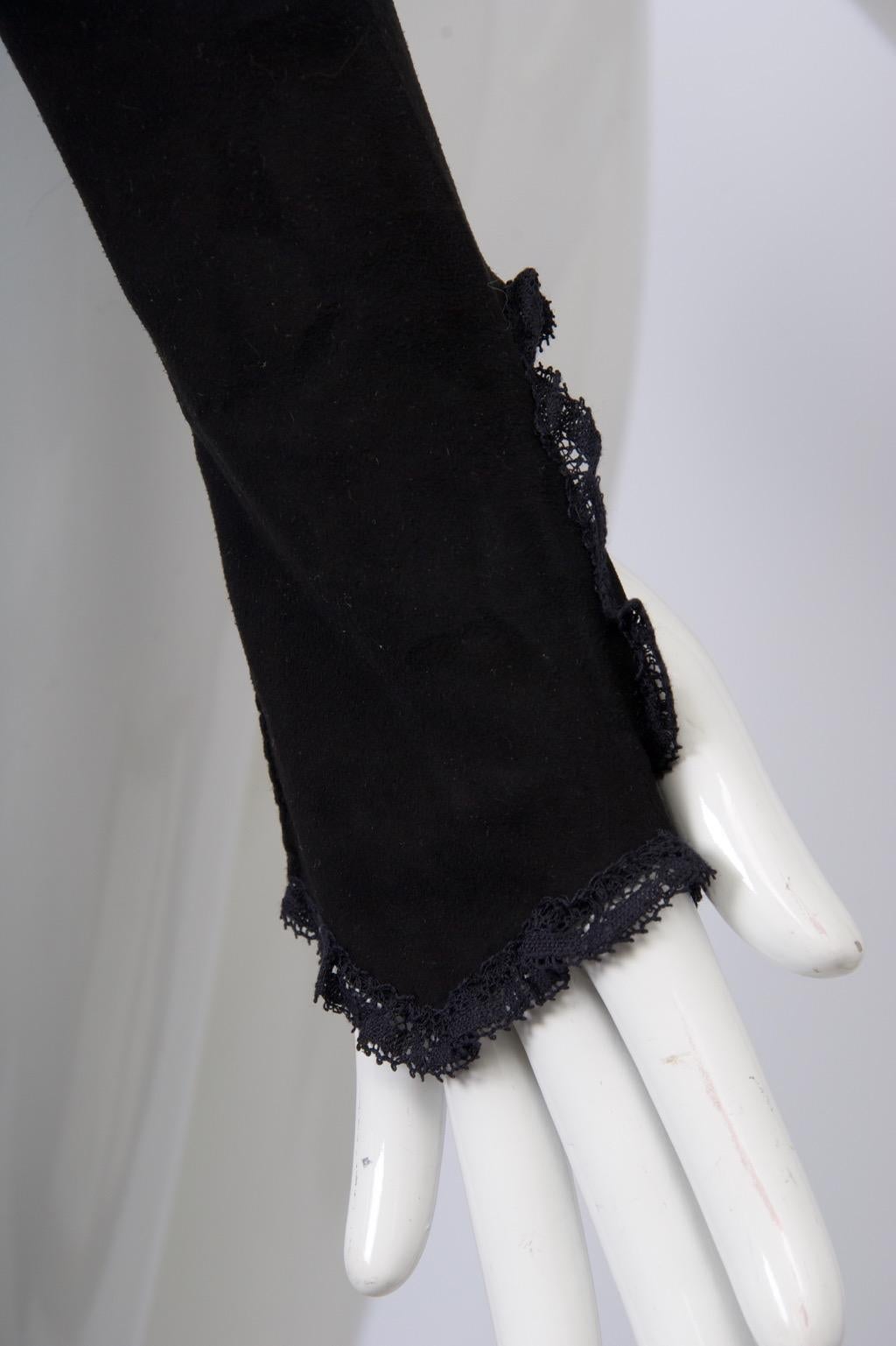 Black suede, fingerless, over-the-elbow gloves are crafted of black suede and trimmed with black lace at all edges. Dramatic and unique.
Trude Schoeman was a well-known designer for Dawnelle Gloves from the 1940s-'60s, when gloves were an essential