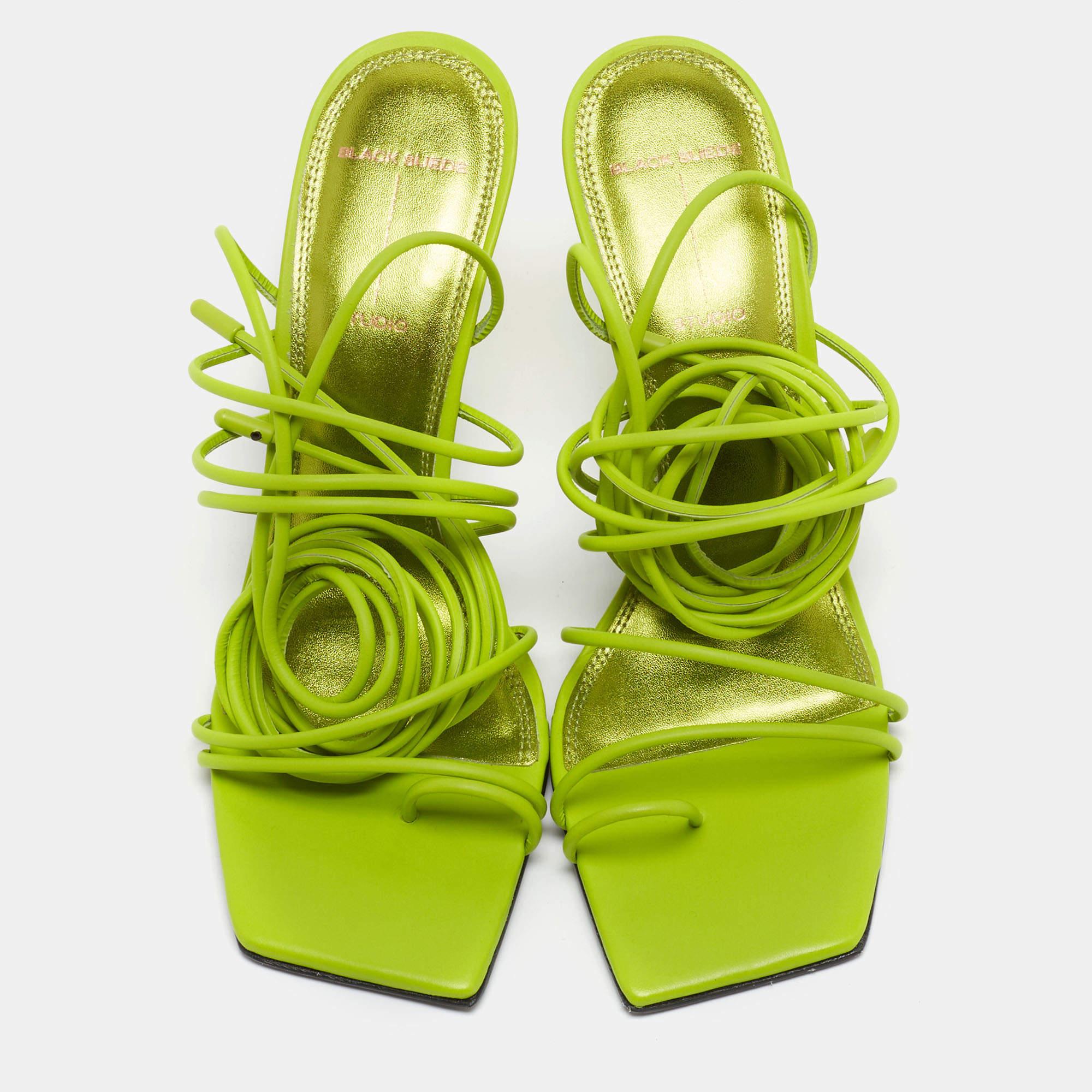 The Black Suede Studio x Caroline sandals are a perfect blend of elegance and comfort. Crafted by the collaboration between Black Suede Studio and Caroline Stanbury, these sandals feature luxurious green leather, a stylish ankle wrap design, and a