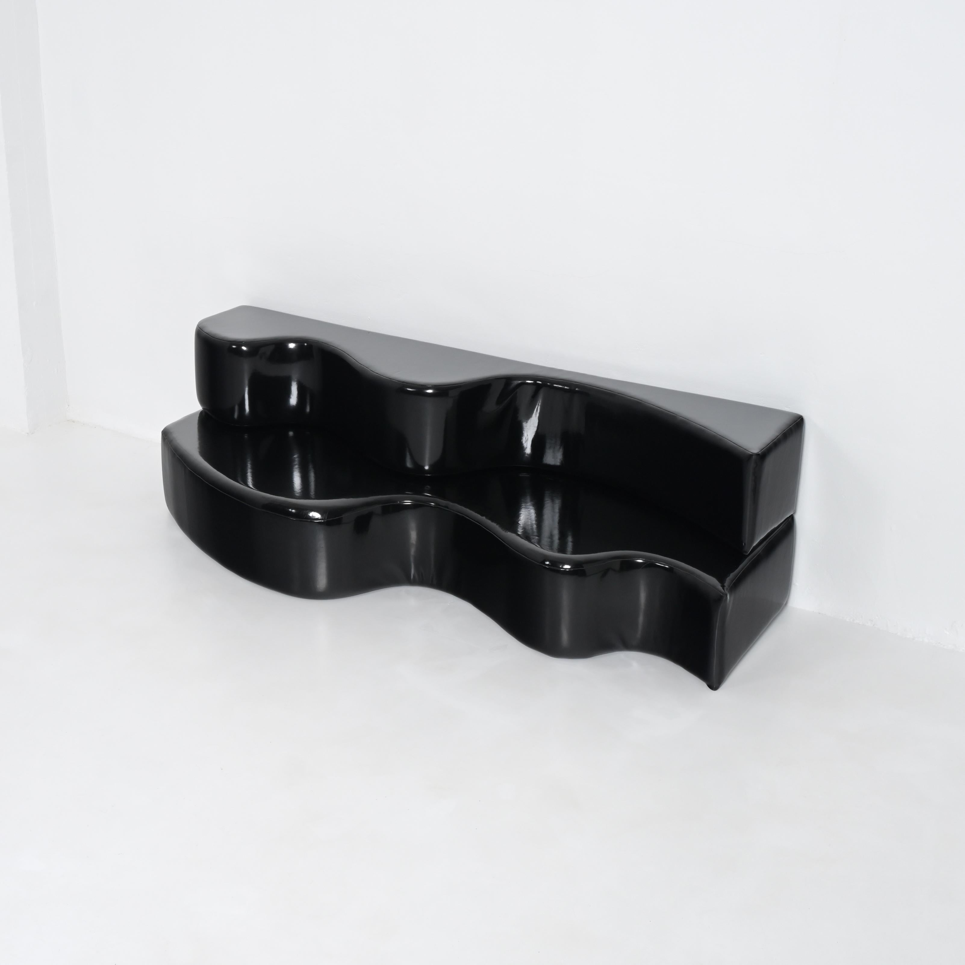Designed in 1967 by the radical group Archizoom, this was the first sofa without a conventional frame. It is composed of two waves made from a polyurethane block cut into two parts with an S—shaped incision, which can be interlocked and stacked to