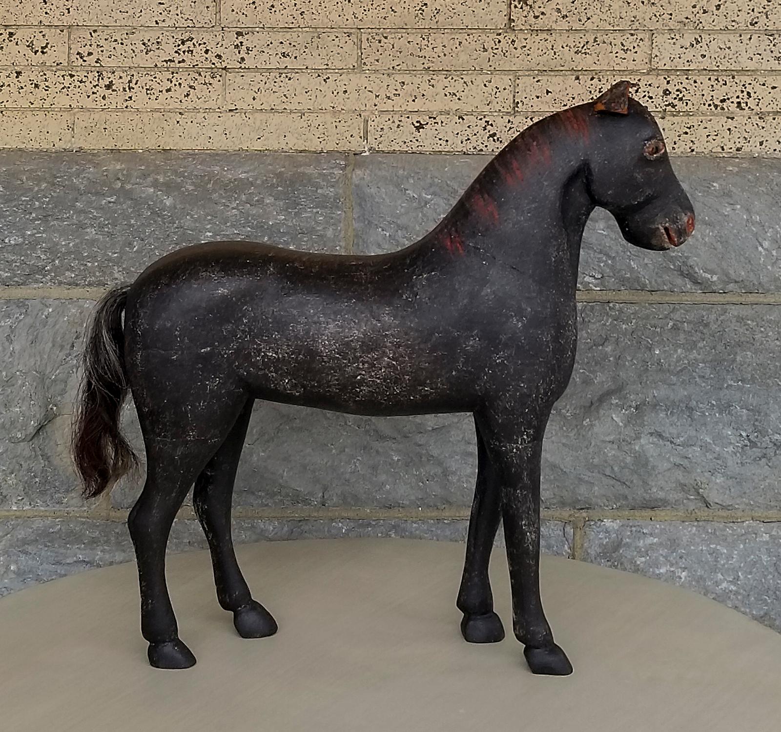 Toy horse from the Gemla Toy factory, Sweden, circa 1890. Original black surface with red painted mane, horse hair tail, and leather ears. Very sweet expression.