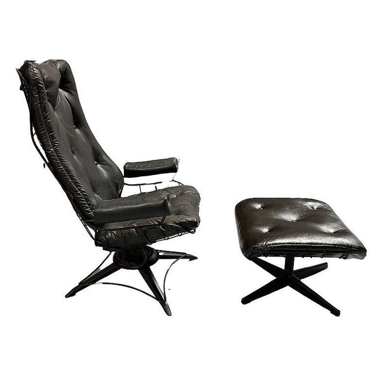 Mid-century Eames-inspired highback black wrought iron springer Lounge Chair with matching ottoman by Homecrest, featuring a rod frame made with a springer rocking swivel. base.

The ottoman includes a large soft pad. top.

Although in fair