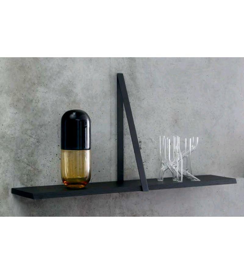 Black T-square shelf by Michael Anastassiades
Materials: Top in natural solid oak matt varnished or solid oak black lacquered. Triangular tray support in black nickel-plated bronze or polished solid brass
Technique: Lacquered wood or polished brass.