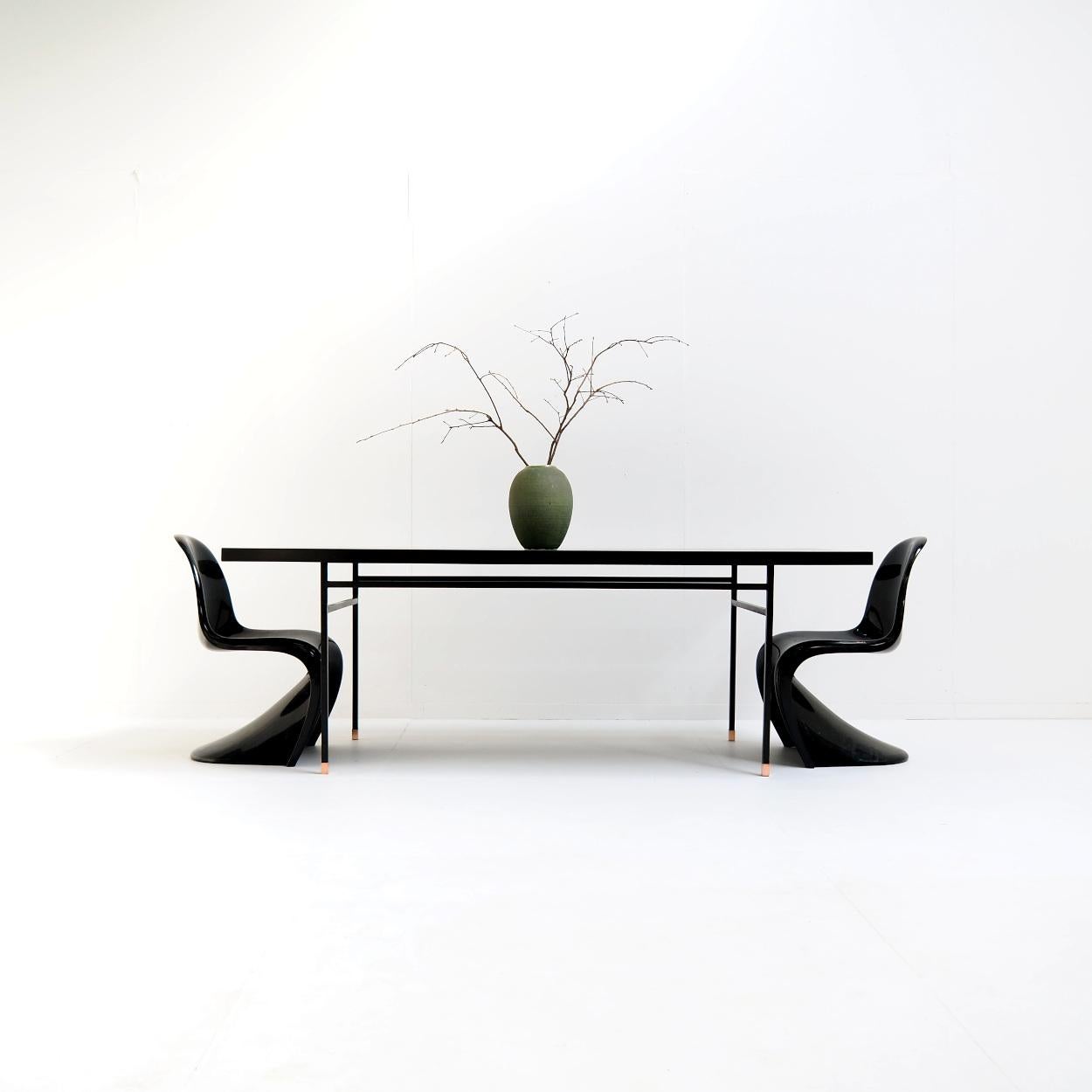 Black dining table attr. to French modernist designer Paul Geoffroy.

The table is a beautiful representative of the French modernism of the 1950s and 60s. A beautiful era with designers like Jacques Adnet, Charlotte Perriand, Pierre Guariche and