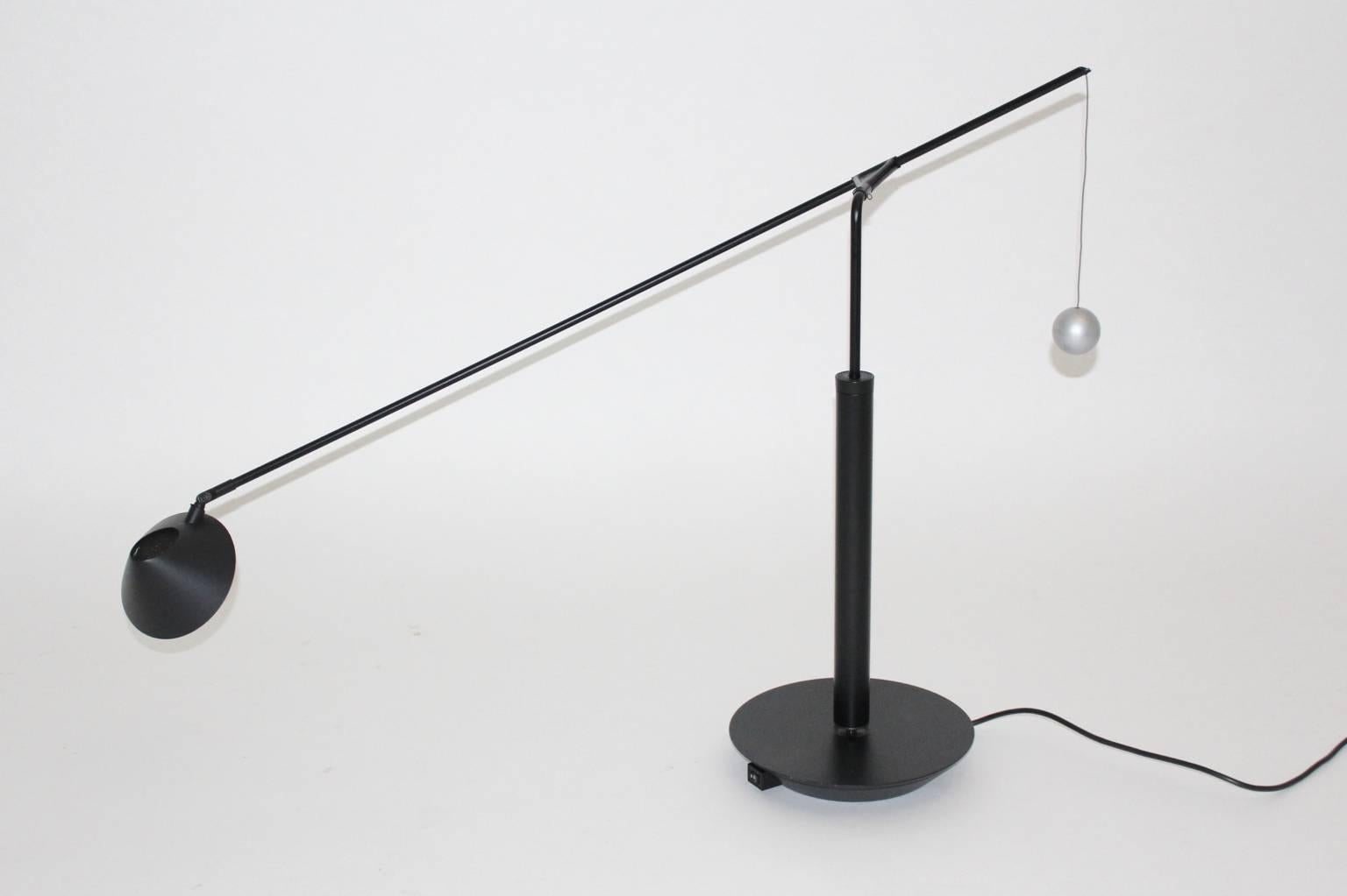 Modern vintage table lamp by Carlo Forcolini 1989 and executed by Artemide Italy.
A gorgeous table lamp from black lacquered metal and plastic. A grey lacquered metal ball features as counterbalance.
So beautiful and practical, the extendable arm is