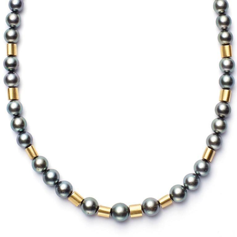 Beautiful Black Tahitian Pearls, indigenous to the tropical paradise, are paired with 18 Karat Gold tube beads, resulting in a  sleek and sophisticated necklace that will flatter any face or fashion. An 18 Karat Gold clasp completes this 18