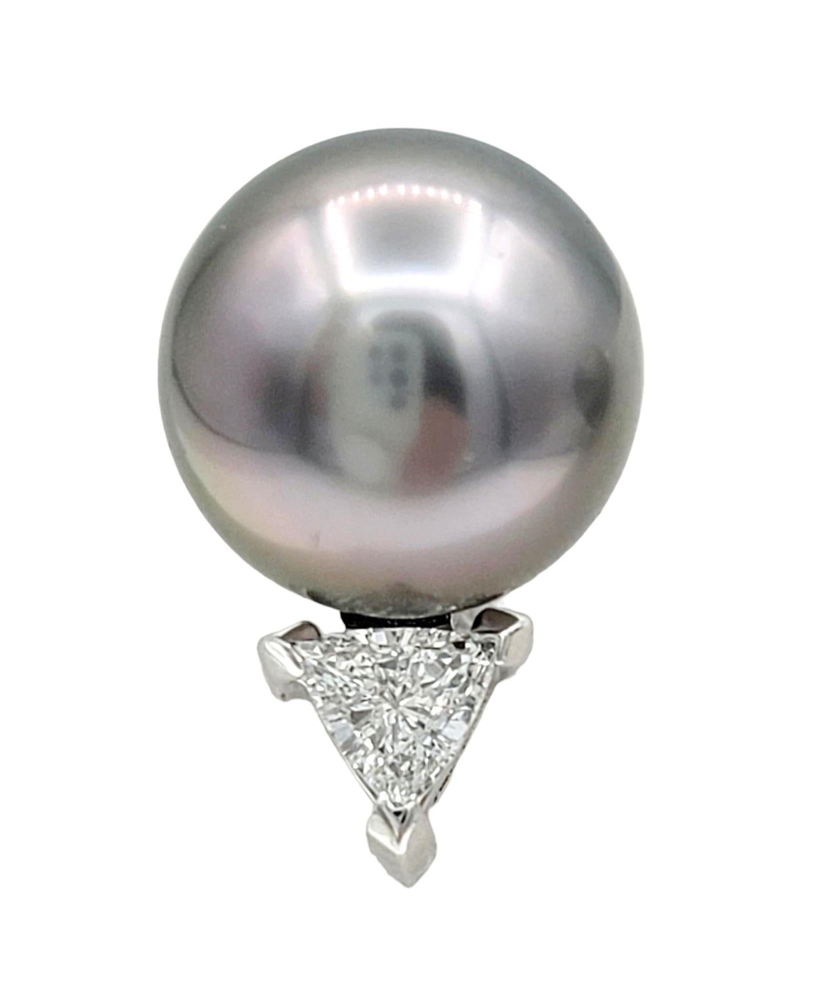 These stud earrings, set in elegant 18 karat white gold, showcase a sophisticated and contrasting design. The focal point of each earring is a lustrous black Tahitian pearl, known for its unique and captivating dark hue. Accompanying each pearl is a
