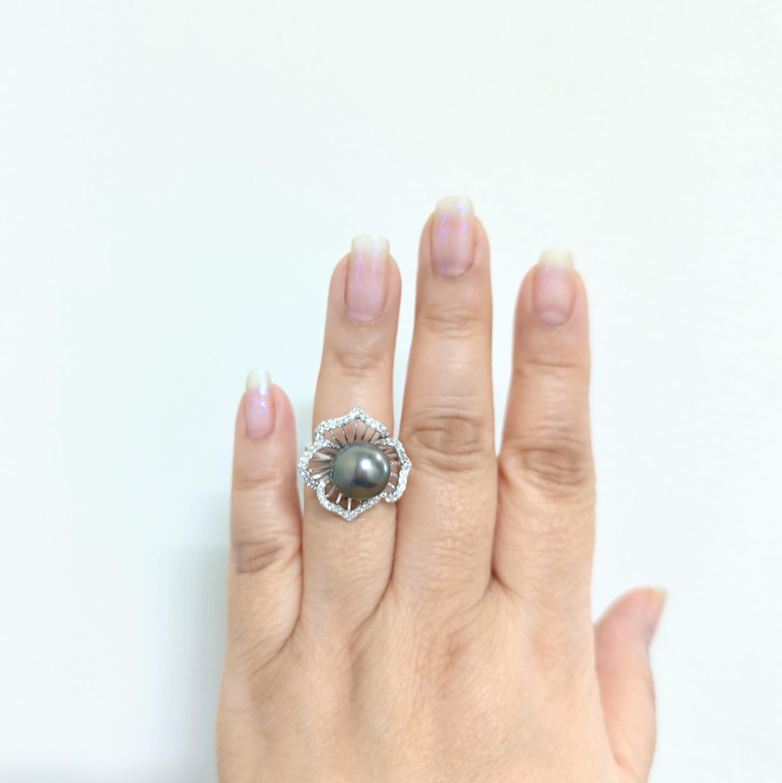 Beautiful big black Tahitian round pearl with good quality white diamond rounds.  Handmade in 18k white gold.  Ring size 6.5.