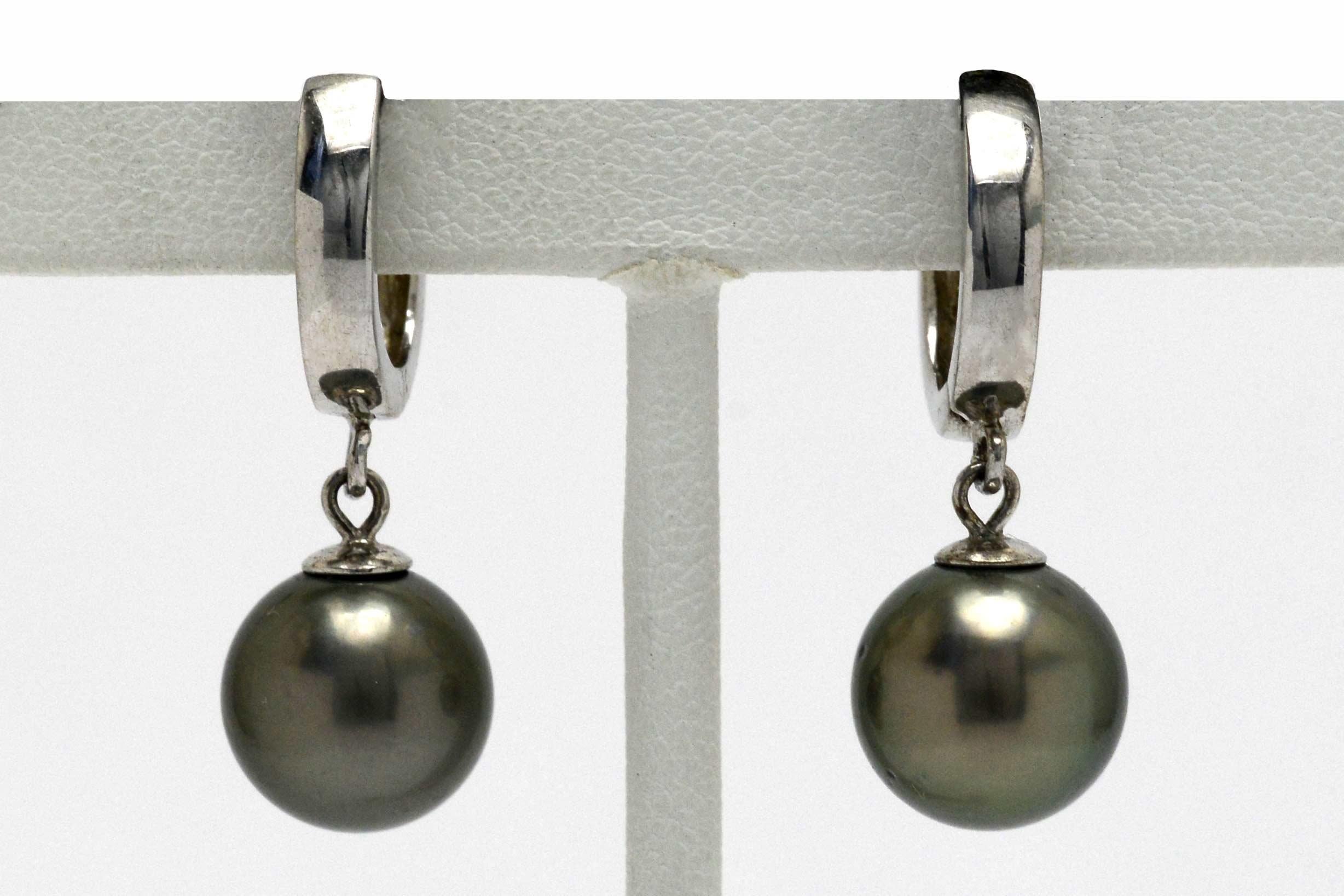 A wonderful pair of Black Tahitian Pearl Dangle Earrings in a desirable large, 10mm size. With the most mesmerizing silvery gray-black overtone and shimmering luster, these eminently wearable drop earrings sway seductively and capture the slightest