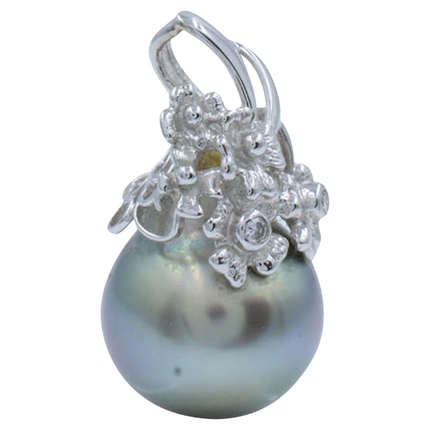 This beautiful pendant is crafted in 14K white gold and encrusted with a black Tahitian pearl and placed in a white gold bail. The bail is set with round cut diamonds just for a touch of sparkle weighing 0.03ct. Pearl measures about 12mm and has a