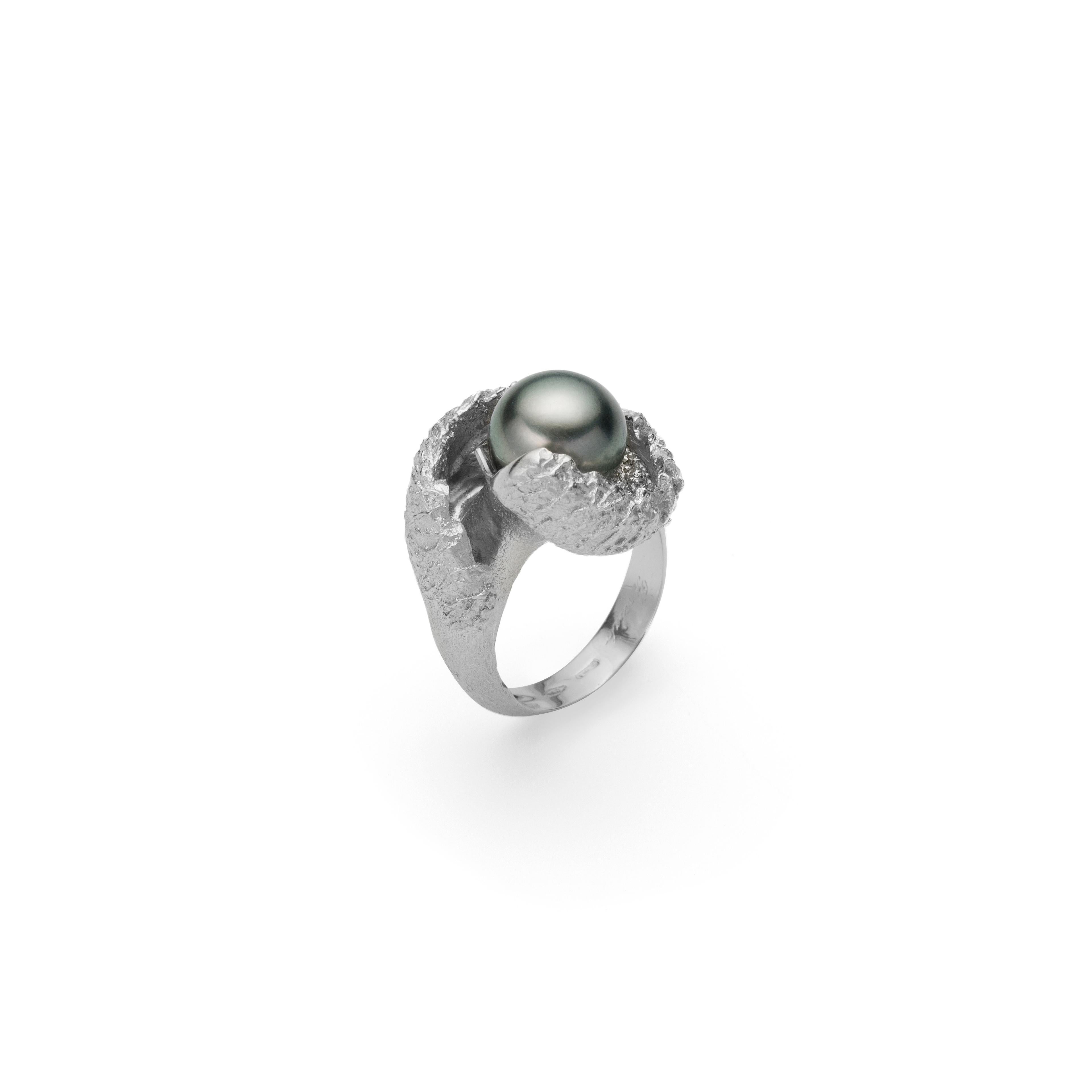 Unique in its design, this alluring ring is handcrafted in 18Kt white gold and features a black Tahiti pearl at the center. This ring is inspired by Mediterranean cliffs kissed by the moonlight. The conceptual idea behind this original design is