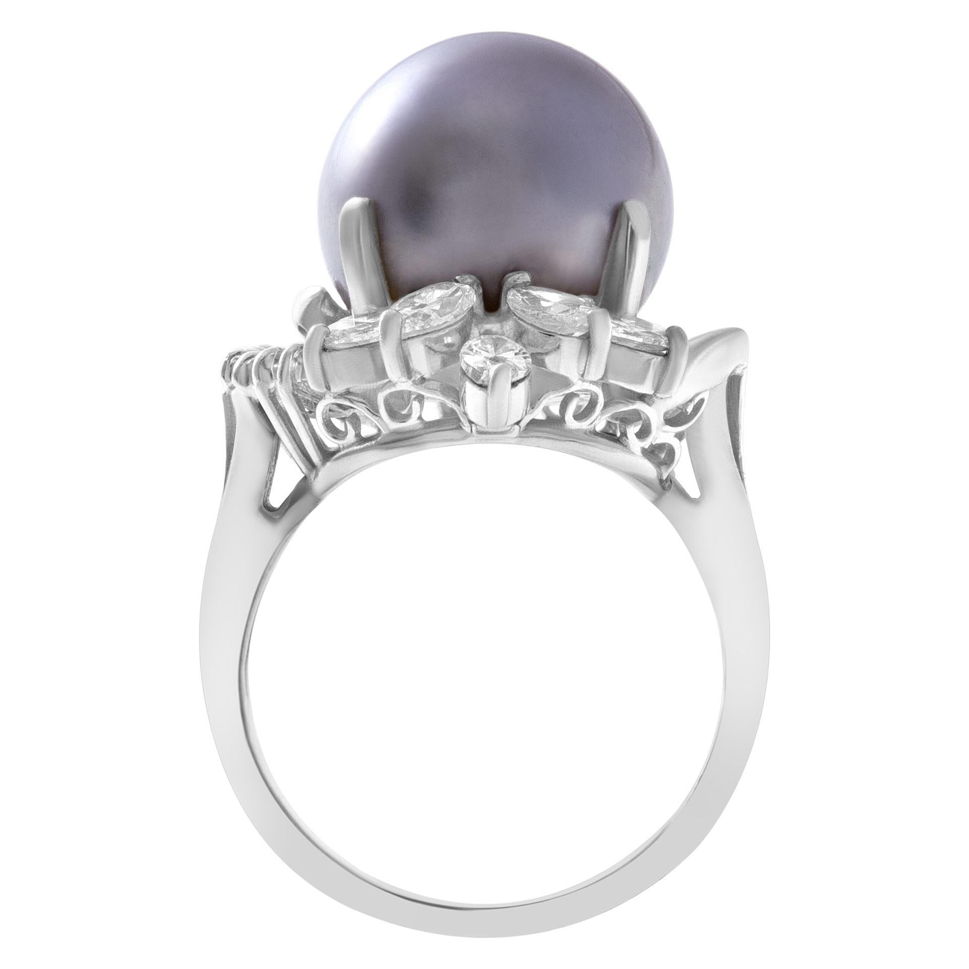 ESTIMATED RETAIL: $5,760 YOUR PRICE: $2,880 - Lustrous black Tahitian pearl ring in 18k white gold. 11mm central pearl surrounded by over 1.0 carats in marquise and baguette diamonds. The width on top: 22mm, width at shank: 3.0mm. Size 7.

