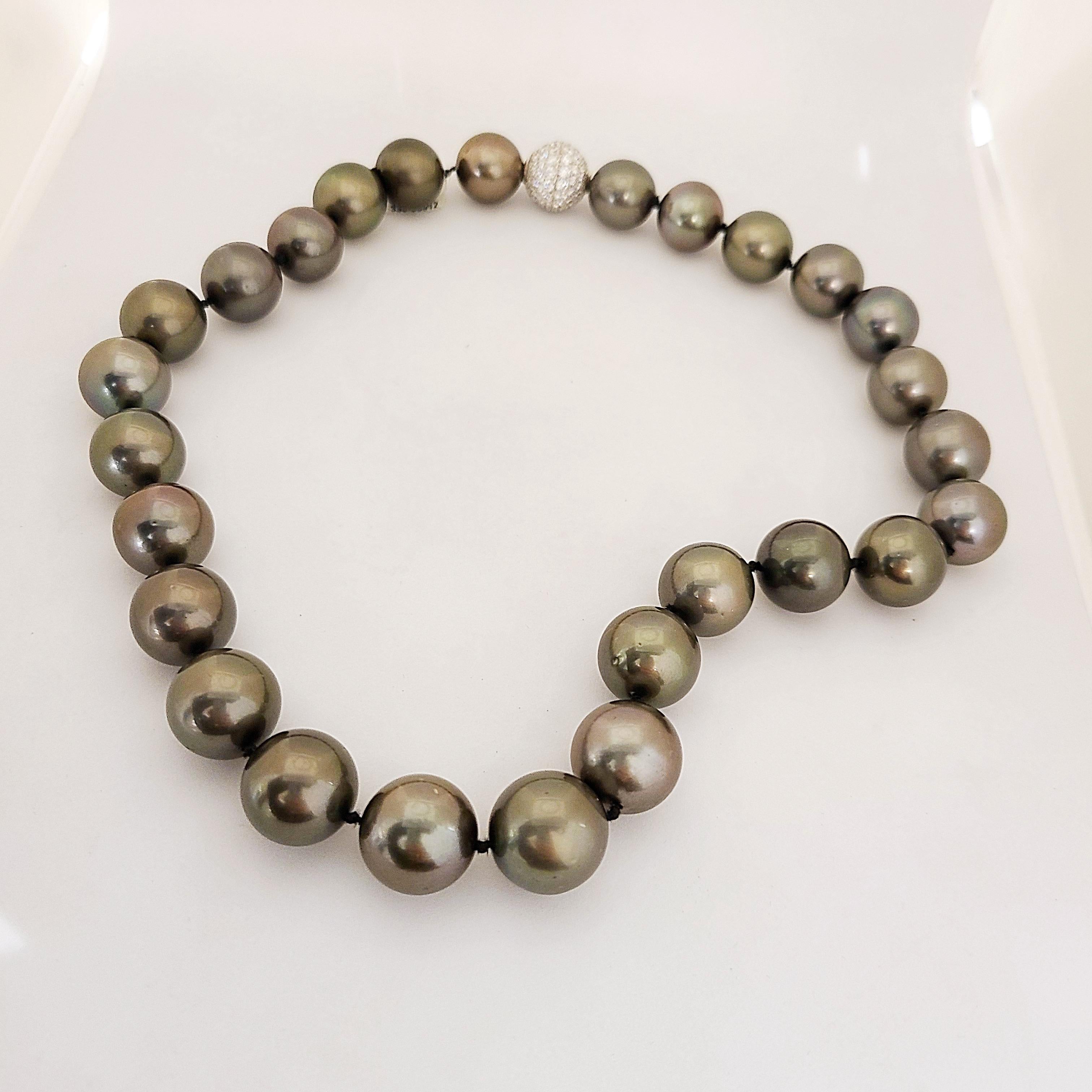 This gorgeous Black Tahitian South Sea pearl necklace features 27 pearls evenly matched for their radiant luster and overtones. With very slight graduation the pearls are 16.7x 15.00mm. The 15 mm platinum and diamond ball clasp is set with 4.58