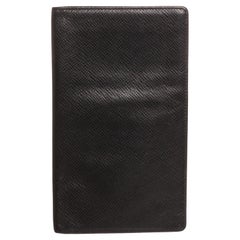 Black taiga leather Louis Vuitton checkbook wallet with tonal leather lining