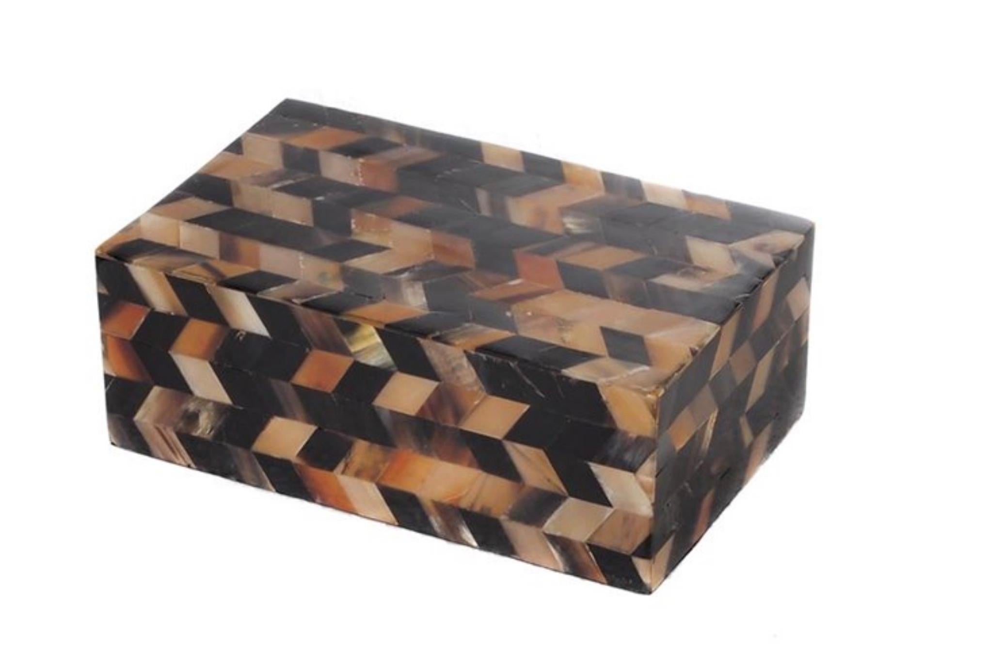 Contemporary inlaid faux horn in shades of black, tan and cream create a three dimensional design.
Decorative and functional.
 