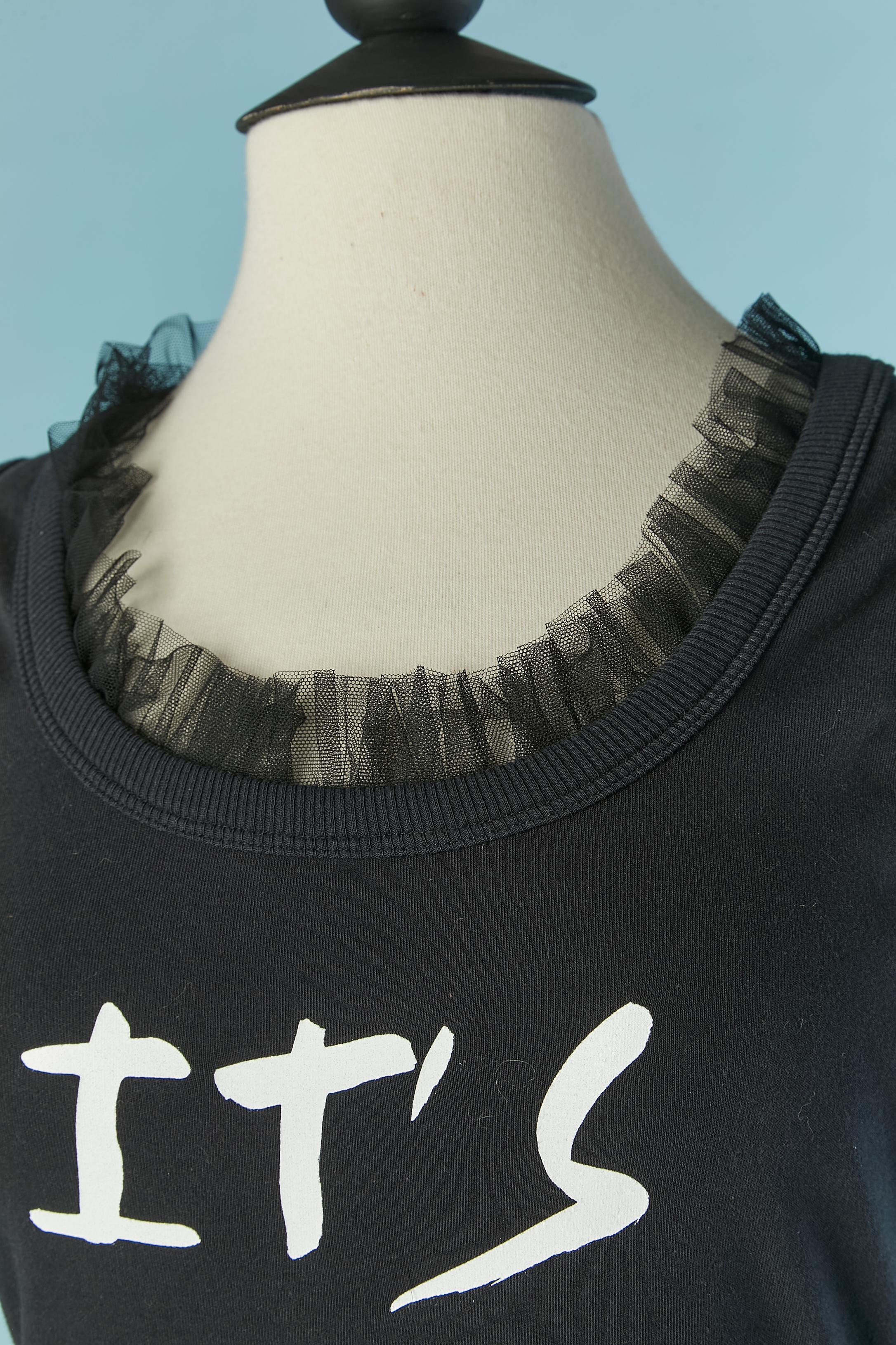 Black tank top cotton dress with writting and tulle ruffles edge. Main fabric composition: 97% cotton, 3% other fibers. 2nd fabric composition ( ribs probably) : 94% cotton, 6% elasthane. 3rd fabric composition ( tulle) : polyamide. 
New with tag.
