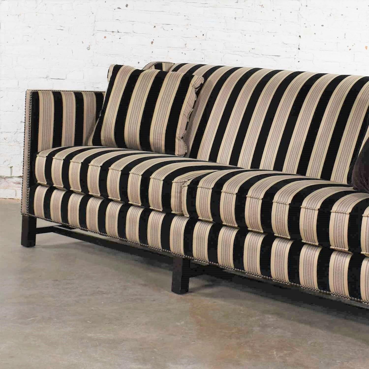 Handsome Bernhardt Interiors tuxedo style sofa with sloped arms in a fabulous black and taupe stripe fabric with nailhead detail and on a black trestle base. It is in incredible ready to use condition. There are some signs of use on the legs but