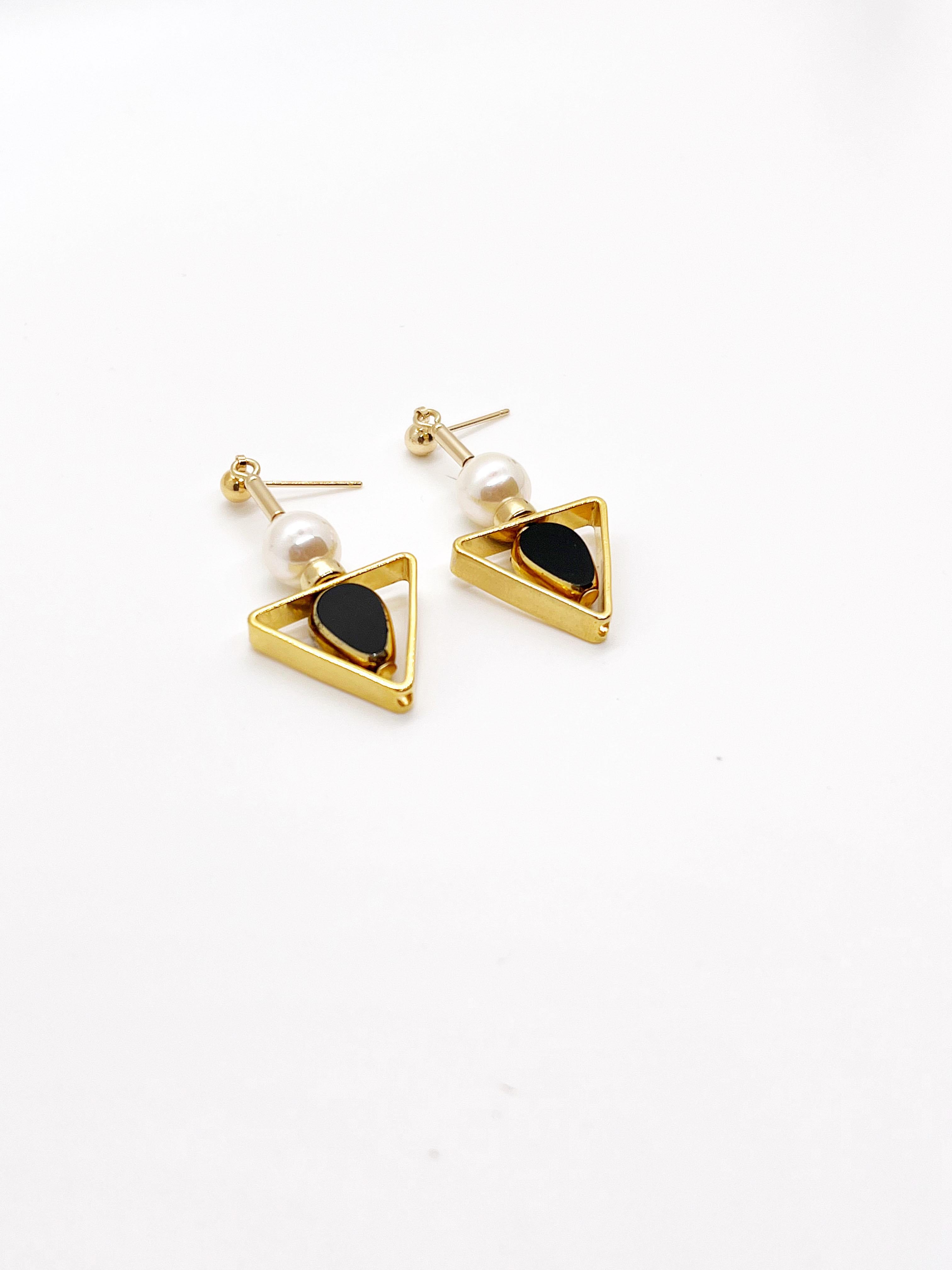 Black teardrop vintage German glass beads edged with 24K gold are complimented with freshwater pearls. The earrings are finished with gold filled earring post and  gold filled beads.

The vintage German glass beads that are edged with 24K gold were