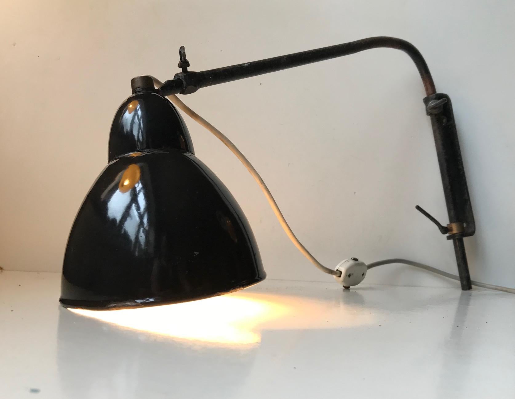 Extendable wall light with side-side, swing arm, adjustable mounts. This light has an Industrial provenance an it came out of a metal workshop in Leipzig Germany where it had been hanging since the 1930s. It has a reach/dept that are adjustable up