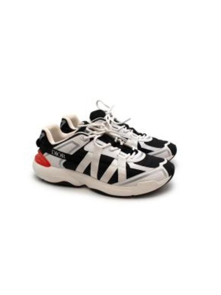 Dior black textile & white canvas trainers
 

 - Chunky black nylon trainers with white canvas strap details 
 - Chunky white rubber sole
 - Padded lining 
 - Silver side logo
 - Red rubber heel detail with debossed logo
 - White laces
 - Logo on
