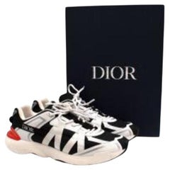 black textile & white canvas trainers