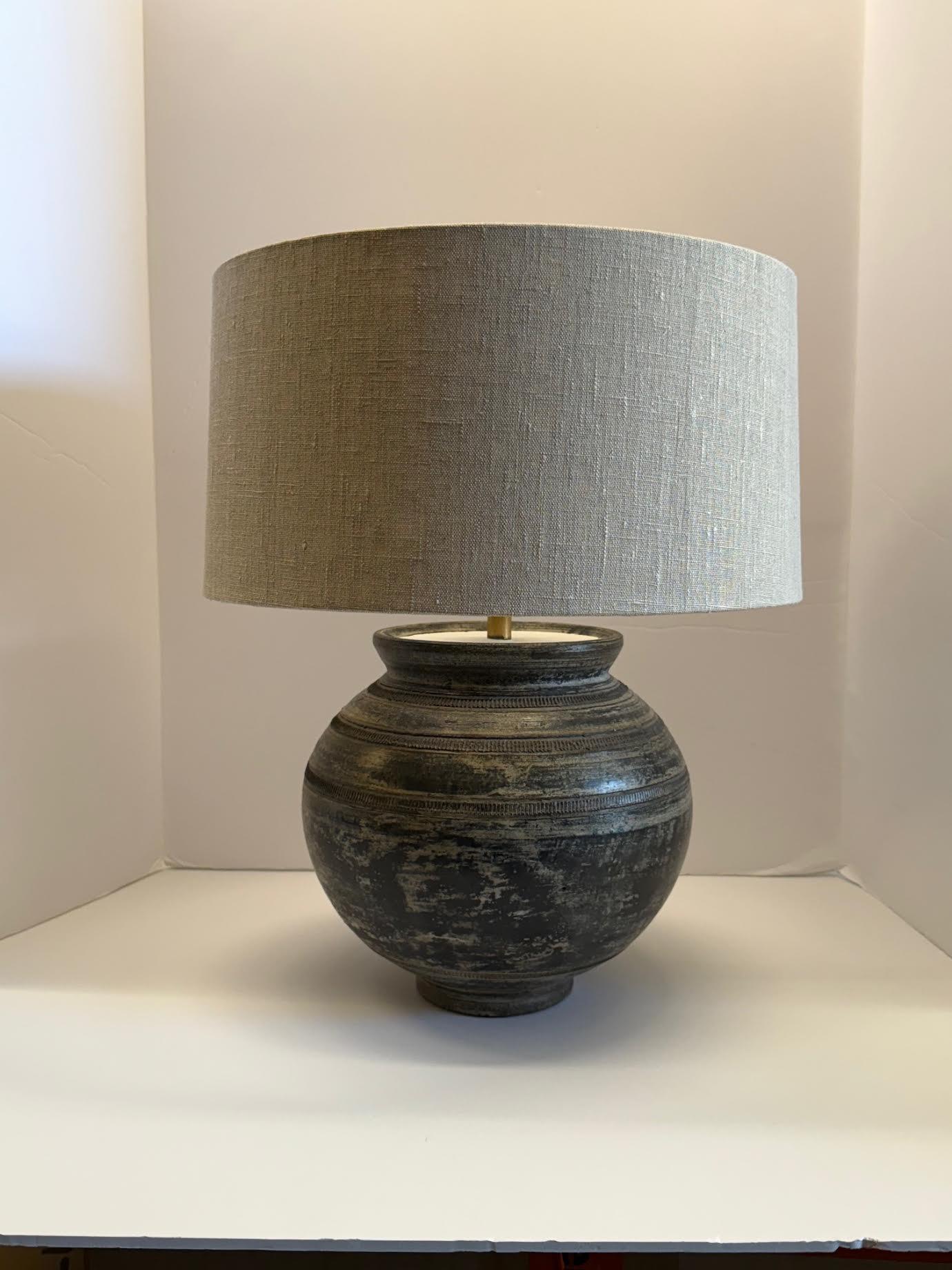 Contemporary Chinese pair textured mottled black ceramic lamps.
Horizontal decorative ridged detailing.
Weathered patina.
Tapered shape.
New Belgian linen shades included.
Base measures 9.5 