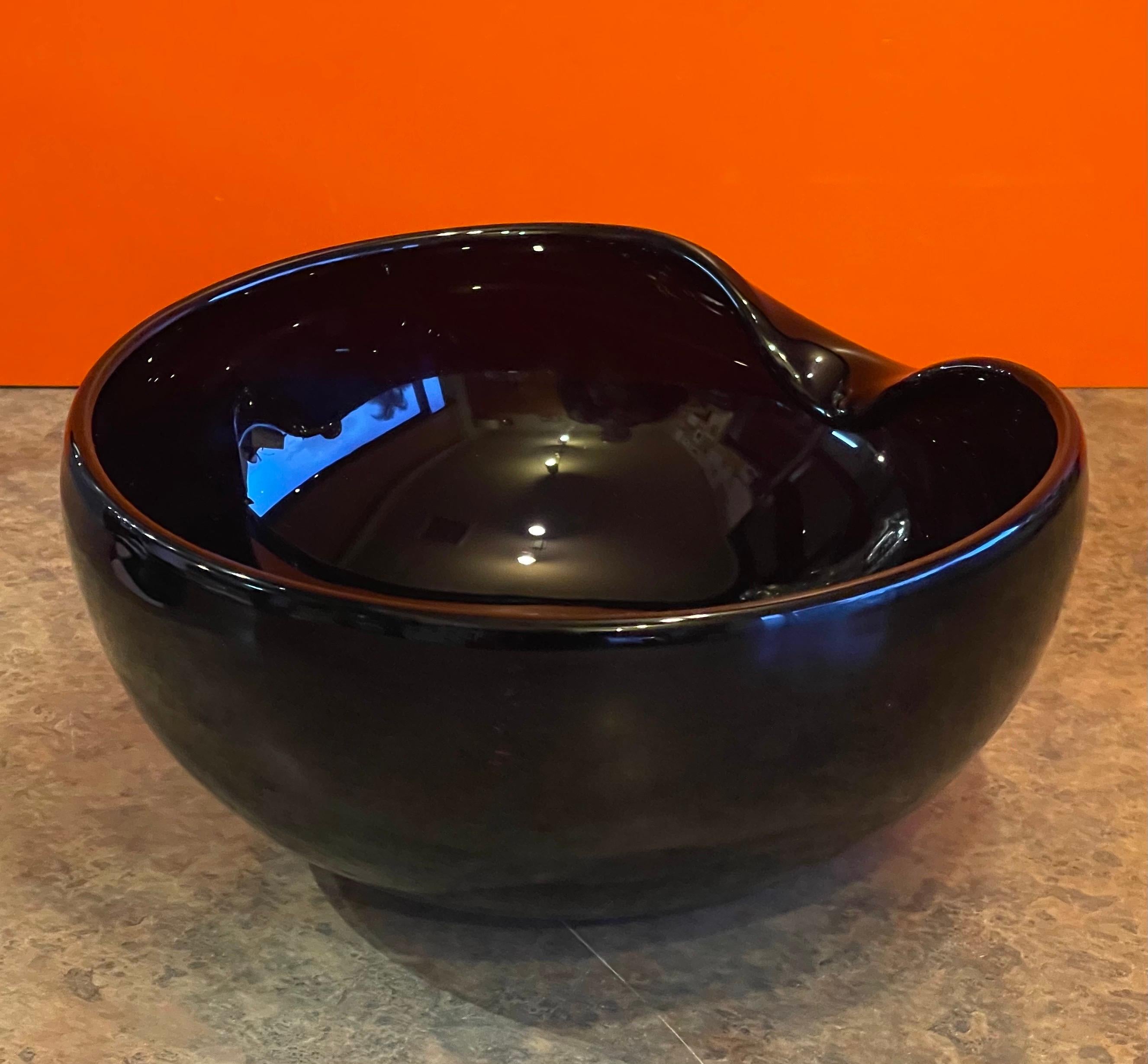 Spectacular black art glass thumbprint centerpiece bowl by Elsa Peretti for Tiffany and Co., circa 1990s. The bowl is in excellent condition and measures 11