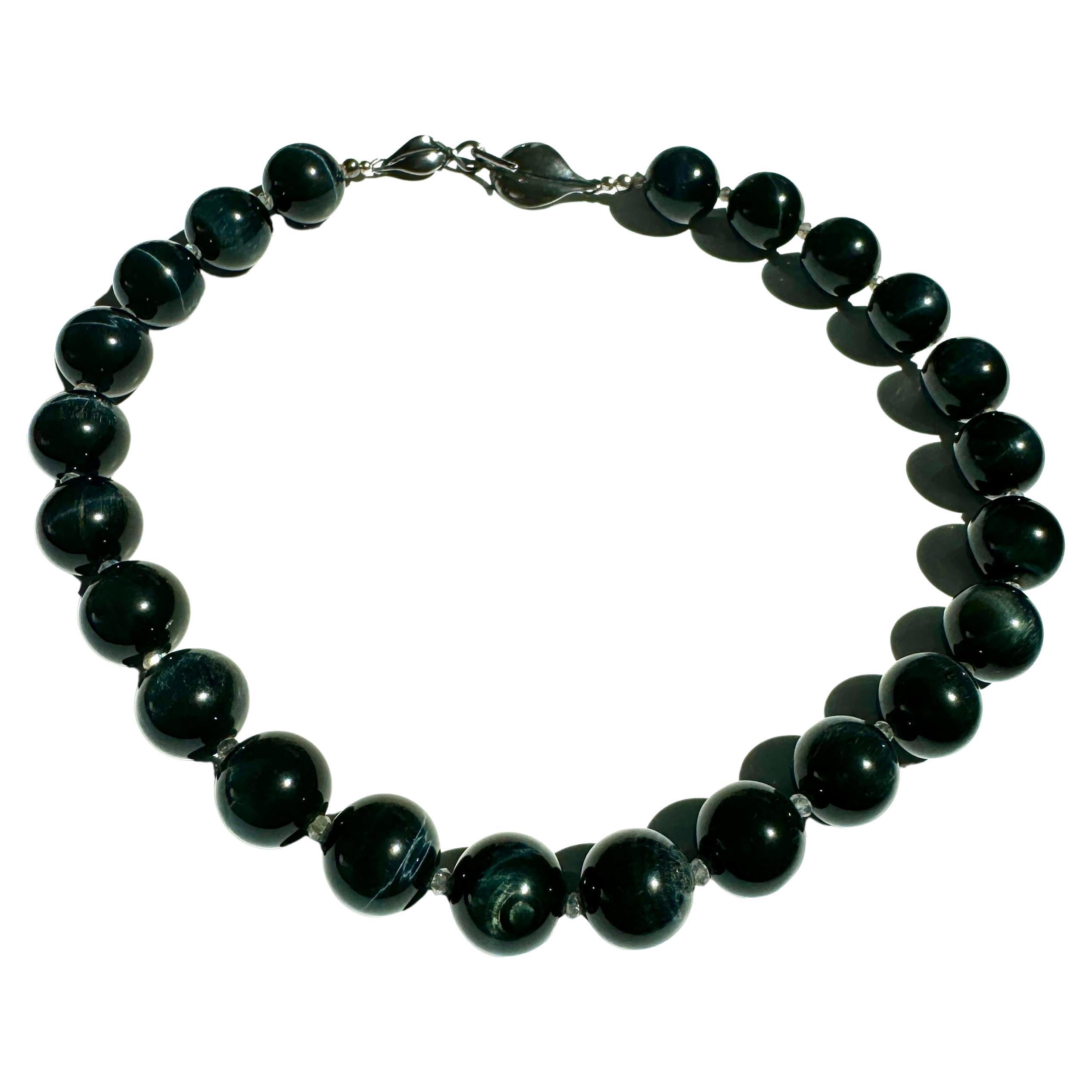 Black Tiger Eye Necklace.
Handmade one of a kind natural large 14mm black round luster tiger eye beads and small labradorite beads, sterling silver clasp leaf design. About 18'5 long. 