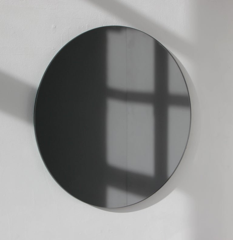 Charming and minimalist round black tinted frameless mirror with a floating effect. Quality design that ensures the mirror sits perfectly parallel to the wall. Designed and made in London, UK.

Fitted with professional plates not visible once