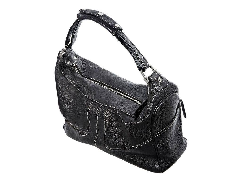 Product details:  Black pebbled leather shoulder bag by Tod's.  Accented with white topstitching.  Single shoulder strap.  Top zip closure.  Lined interior with inner zip pocket.  Front exterior zip pockets.  Side exterior slide pockets.  Protective