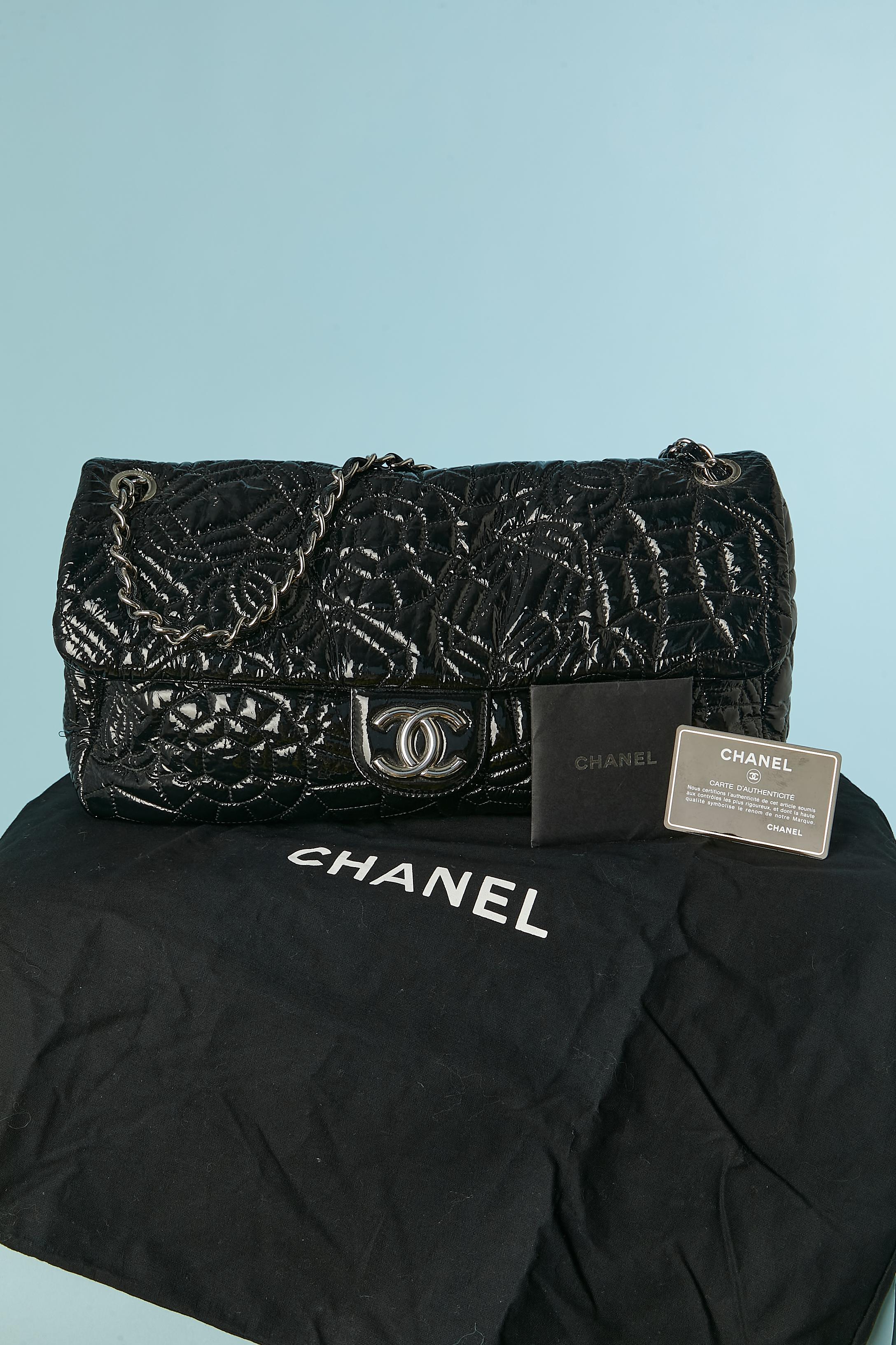 Black top-stitched patent leather shoulder bag. Snap closure on the middle front under the flap. Grey satin lining. One pocket inside with zip closure. 
Authenticity card. Numbered. 
SIZE: 36cm X 18cm X 8cm 