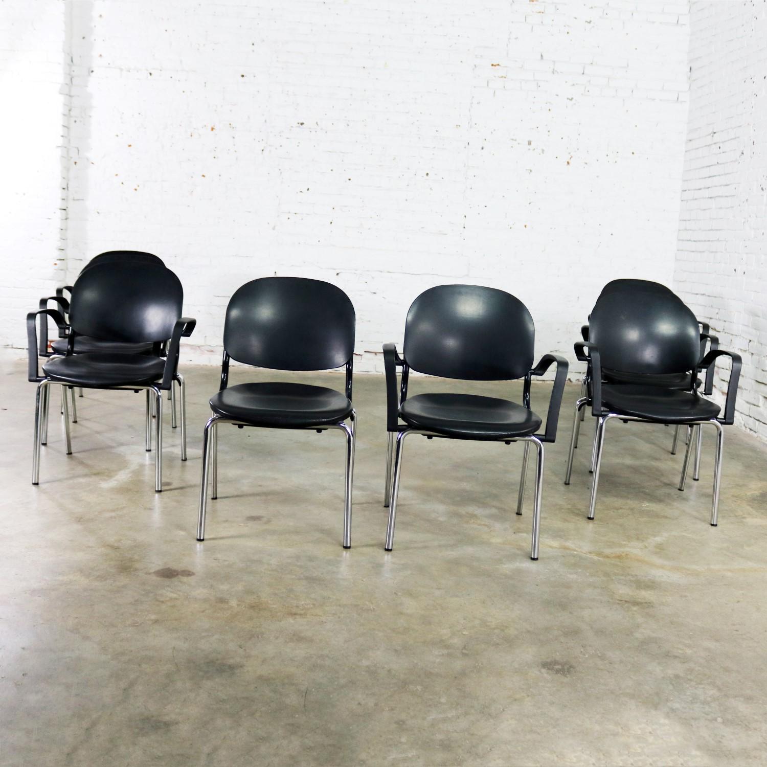Excellent set of eight black Torsion dining chairs designed by Giancarlo Piretti for KI. There are seven arm chairs and one side chair. They are in wonderful vintage condition with minor wear that you would expect with age. Please see photos, circa