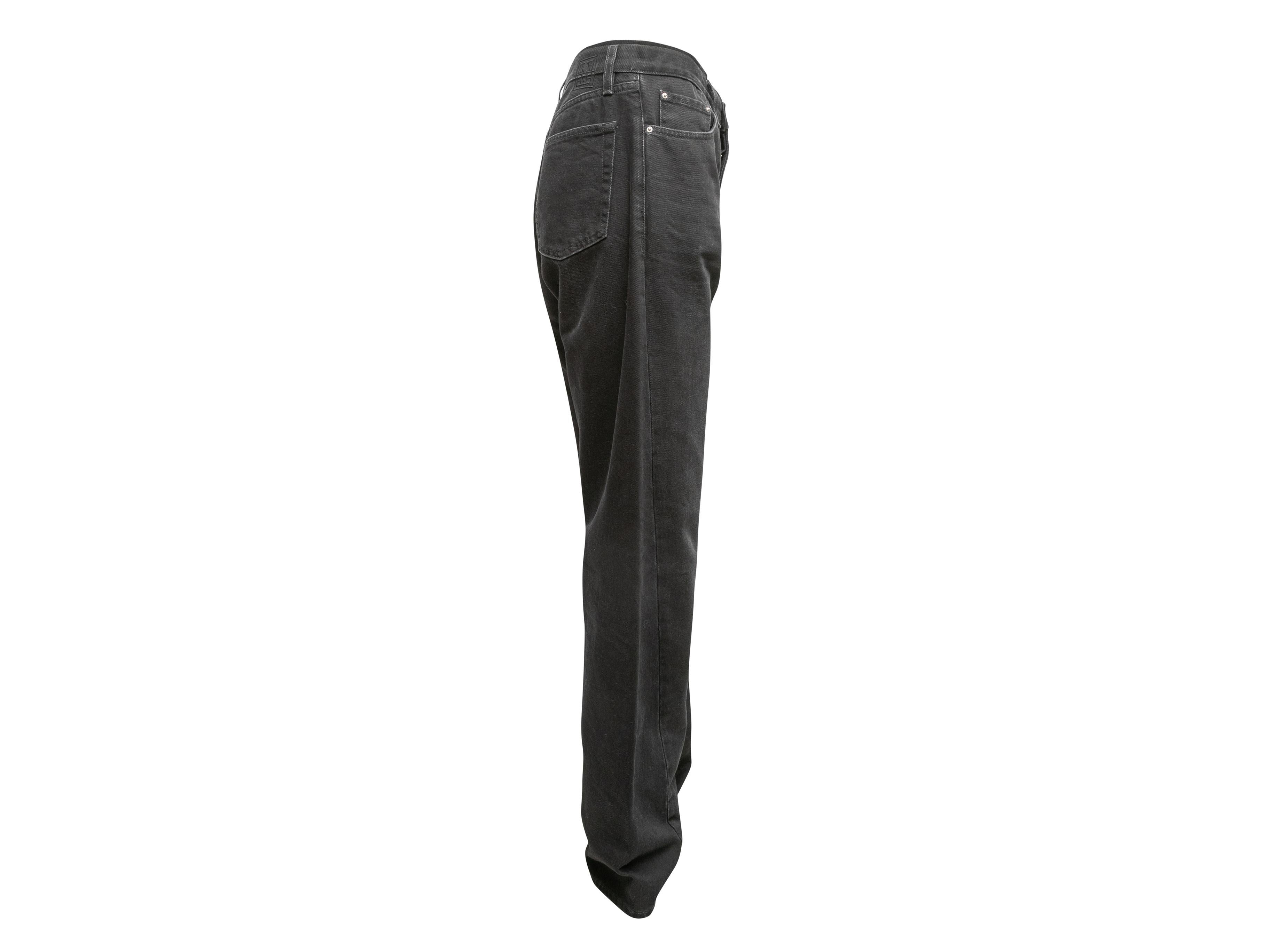Black wide-leg jeans by Toteme. Five pockets. Zip and button closures at front. 30